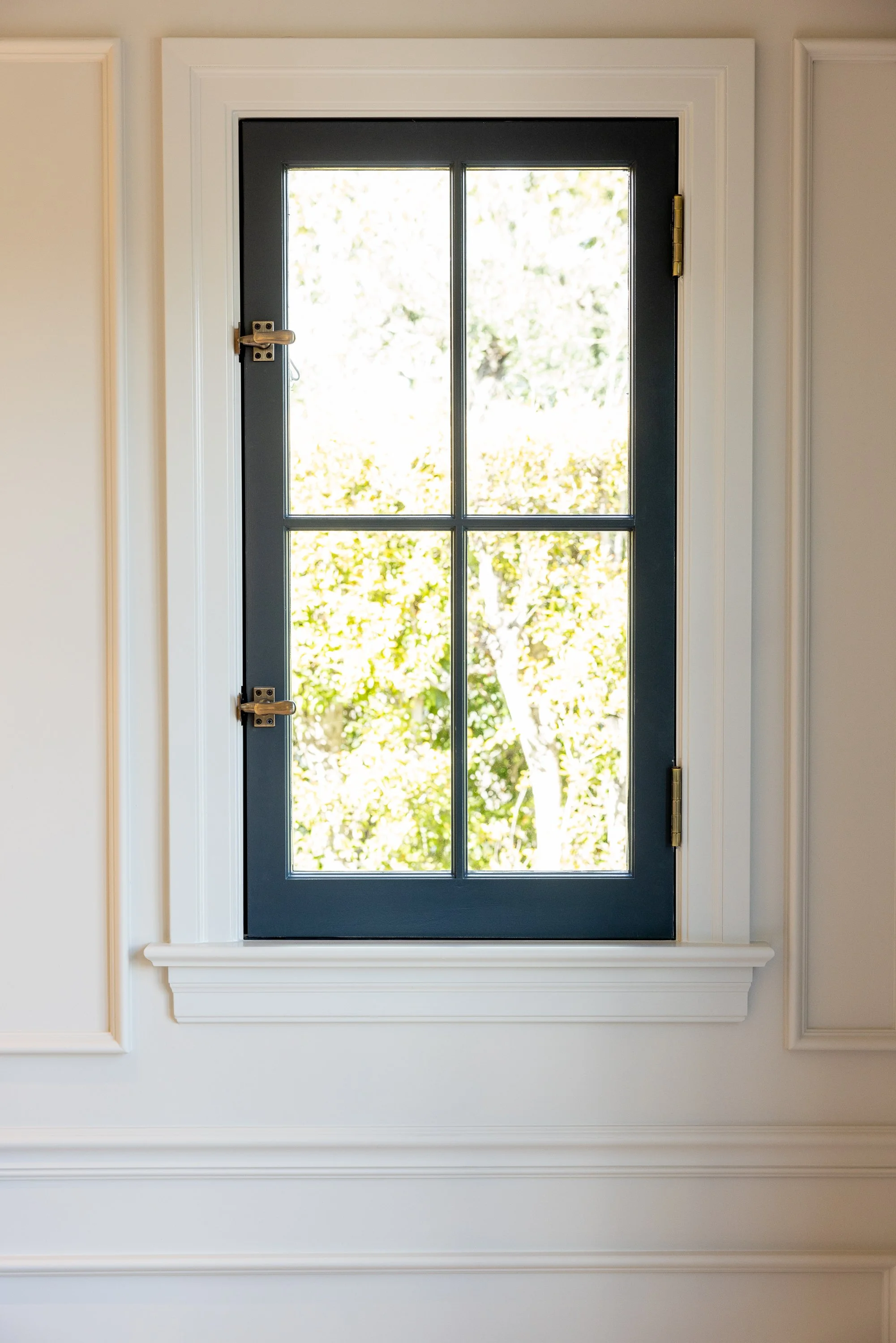 Custom steel-framed window bringing natural light into a beautifully restored Hancock Park residence by JBurton General Contractor.