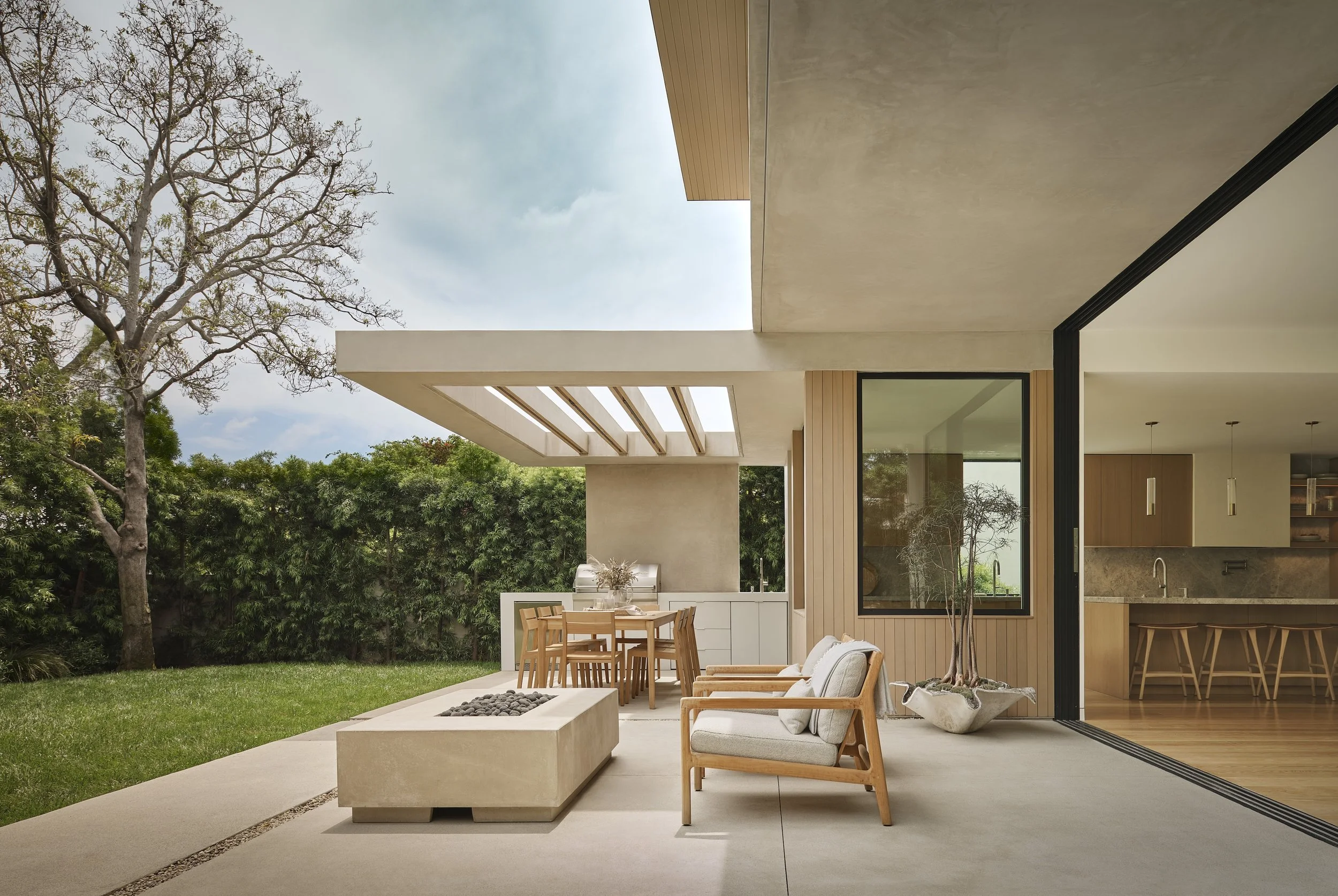 Covered outdoor patio with lounge seating, dining area, and seamless indoor-outdoor living, remodeled by JBurton General Contractor in Westwood, Los Angeles.