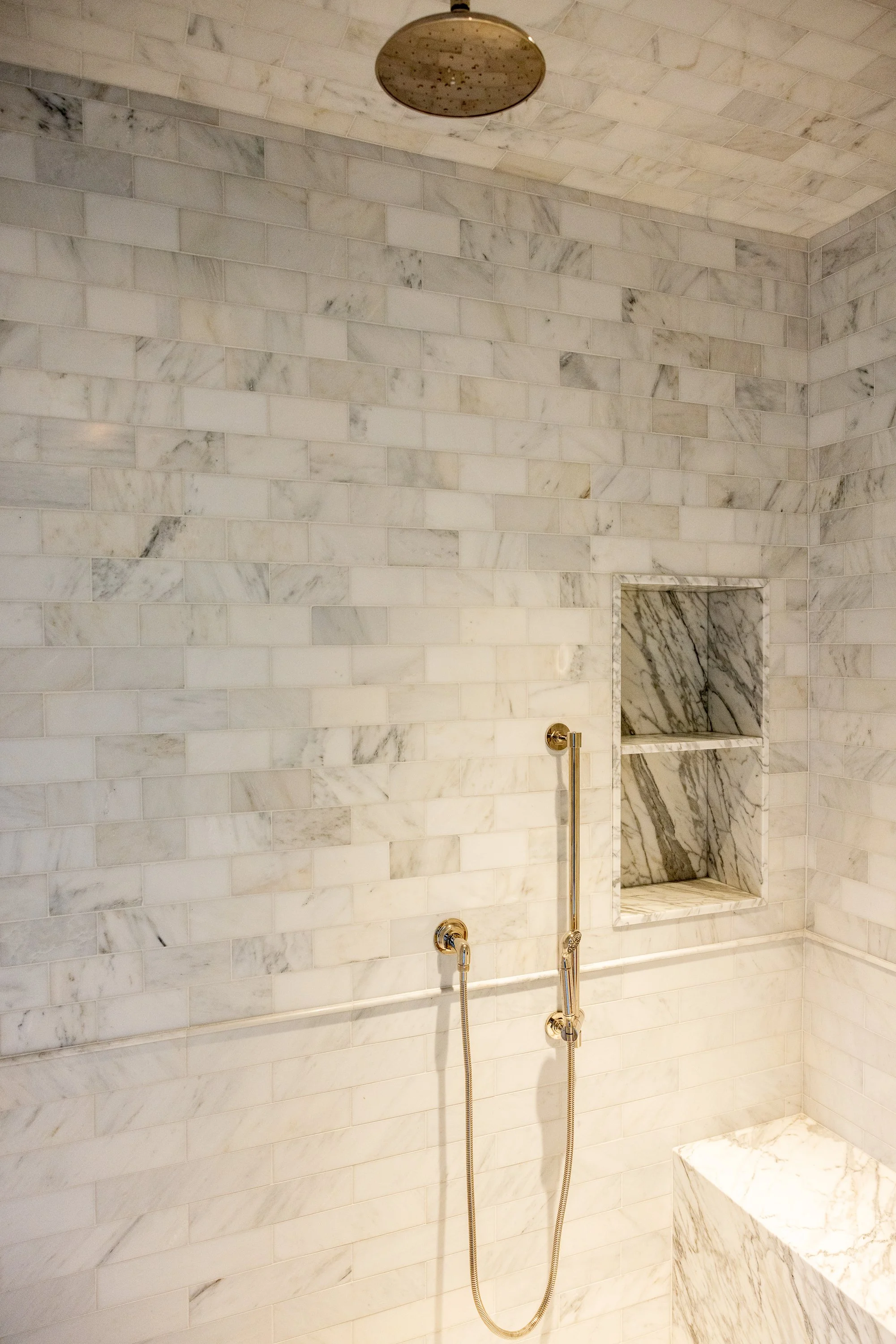 Luxury marble shower with built-in niches and timeless brass fixtures, completed by JBurton General Contractor in Hancock Park, Los Angeles.
