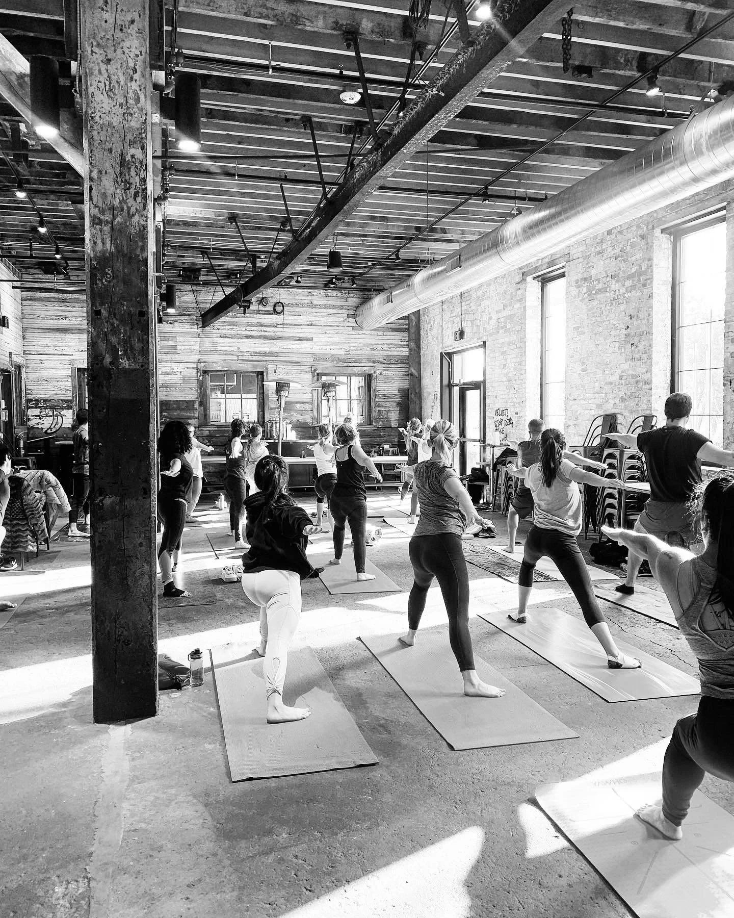 Community wellness session in a creative industrial space by RLVNT Group