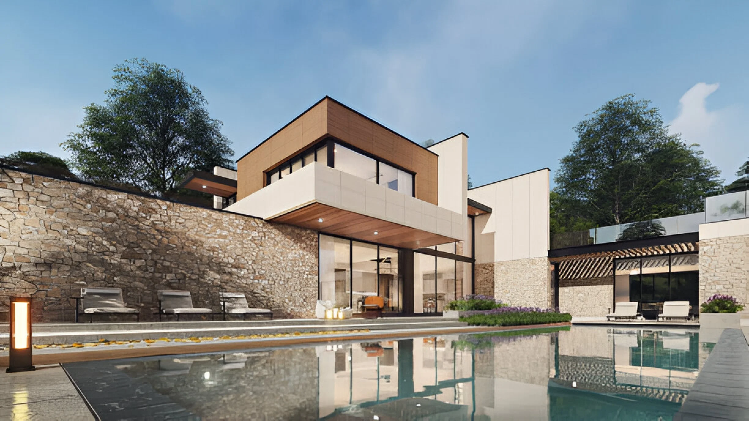 Modern house with large glass windows and a swimming pool, surrounded by a stone wall and patio furniture, with trees and a blue sky in the background.