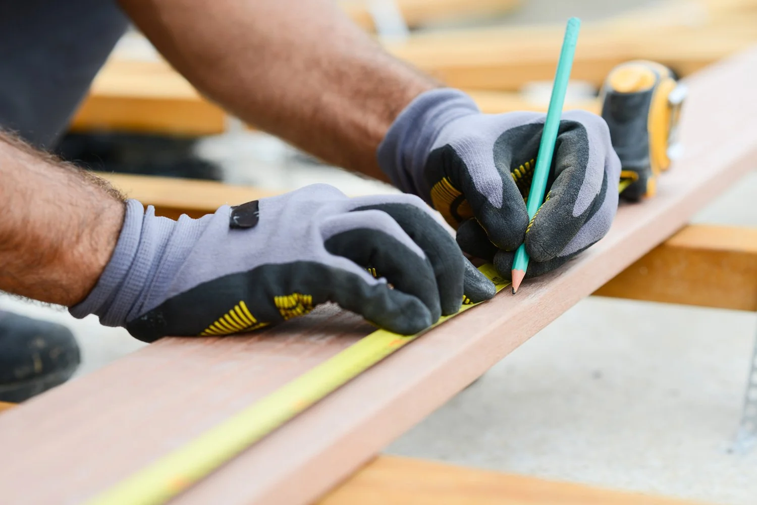 Rafael Contreras measuring and cutting trim on a job site in Ferndale, WA