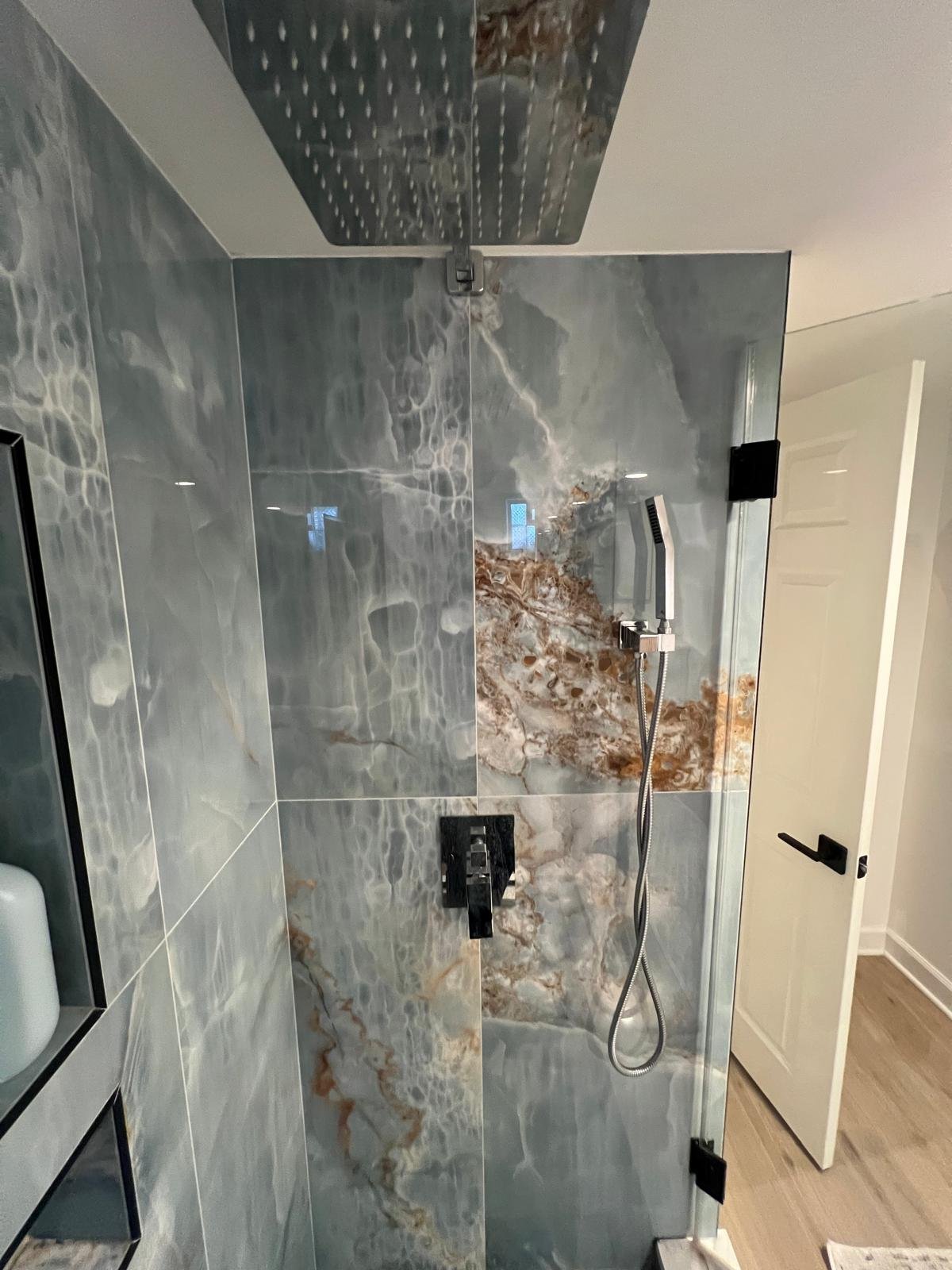 standing shower with blue marbled porcelain tile and recessed niches, quartz step, chrome shower system, frameless shower glass with black hardware
Interior Designer - Chicago
interior design chicago
kitchen designer chicago
bathroom designer chicago