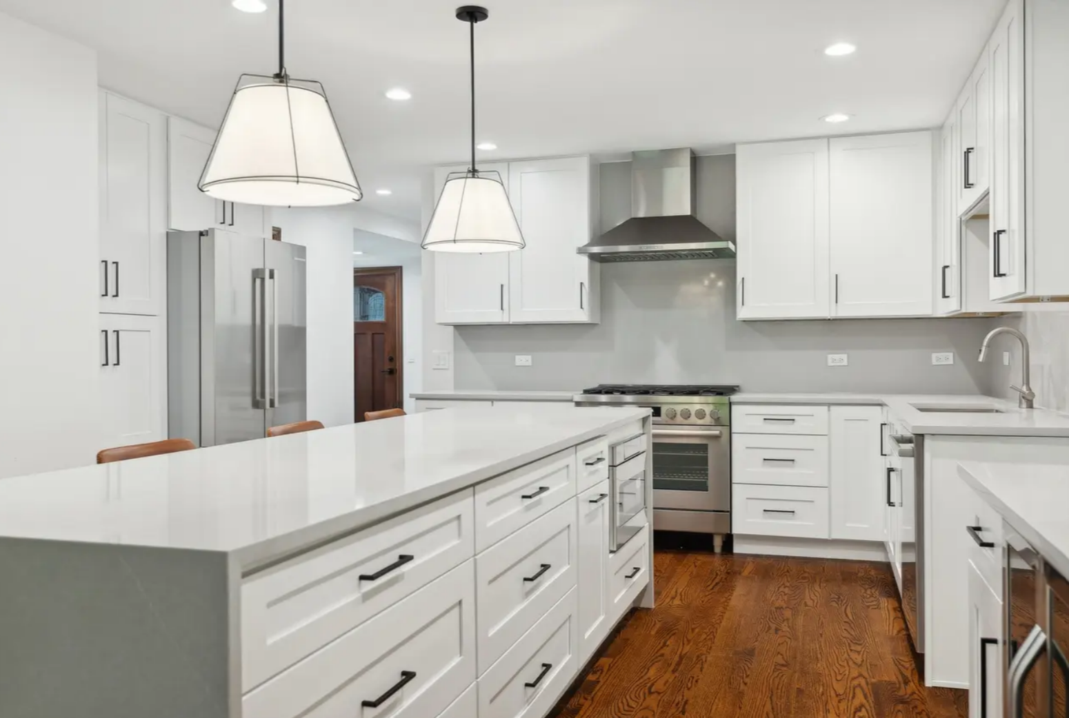 kitchen renovation with white shaker cabinets, gray quartz countertops, waterfall edge countertops, full quartz backsplash, island microwave, new appliances, range hood, island pendant lights
interior designer - chicago
interior design chicago
kitche