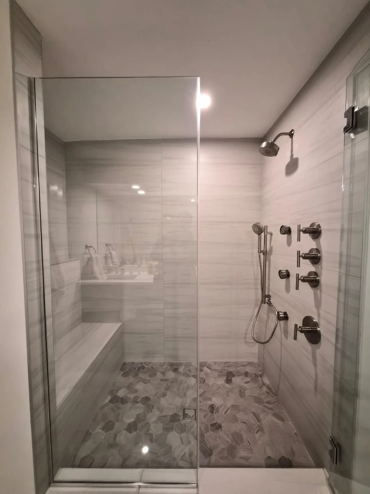 We always like to use a tough situation to make things better! Our client moved into their new home with a newly redone shower that was graded in the wrong directions. We took that opportunity to reconfigure the shower and give it a fresh neutral loo