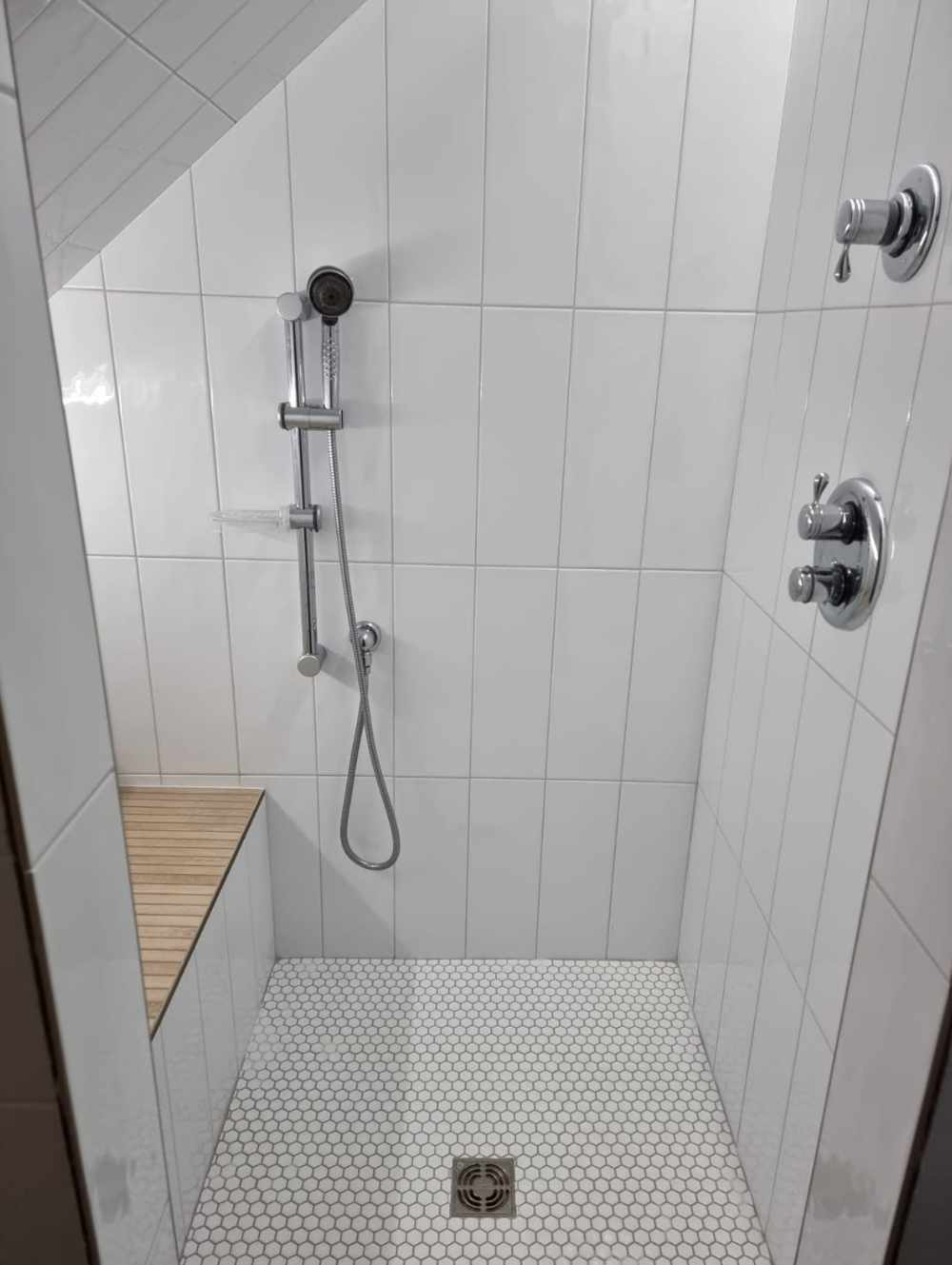 bathroom renovation with Scandinavian style, chrome plumbing, white subway tile, white penny tile, wood-looking tile on built-in bench and shelf with glass door
interior designer chicago
interior design chicago
bathroom design chicago