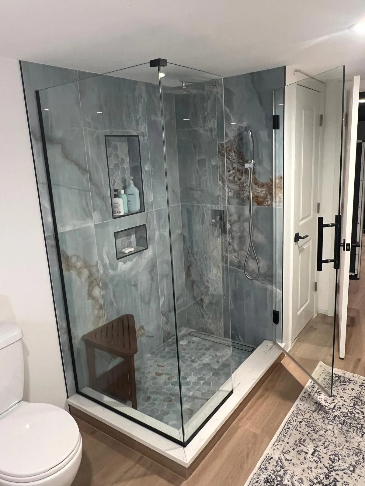 standing shower with blue marbled porcelain tile and recessed niches, quartz step, chrome shower system, frameless shower glass with black hardware
Interior Designer - Chicago
interior design chicago
kitchen designer chicago
bathroom designer chicago