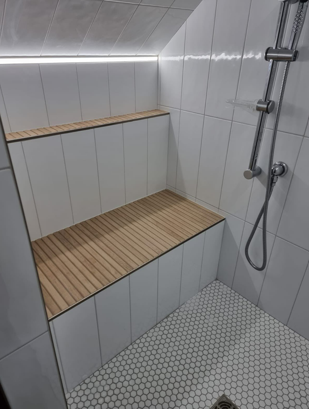 bathroom renovation with Scandinavian style, chrome plumbing, white subway tile, white penny tile, wood-looking tile on built-in bench and shelf with glass door
interior designer chicago
interior design chicago
bathroom design chicago