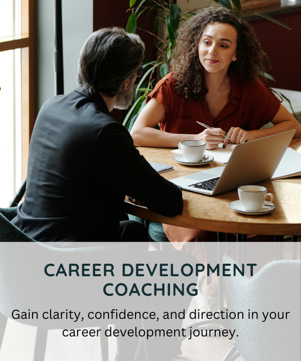 A woman and a man having a discussion at a table during a career development coaching session.