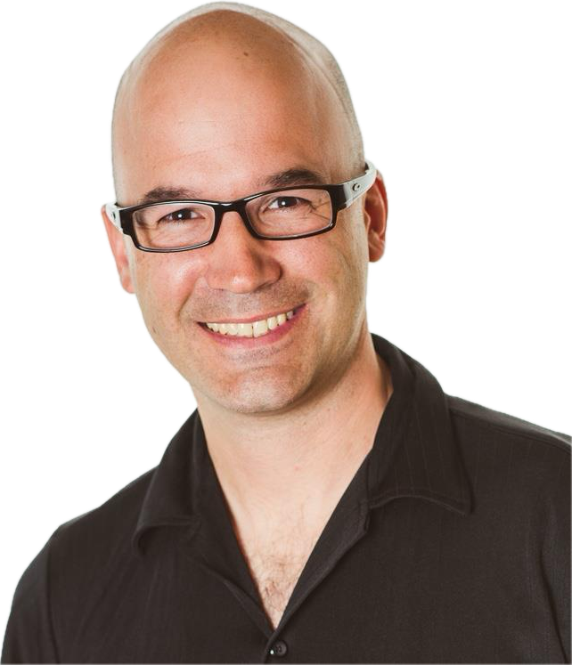 A smiling man with glasses, a shaved head, and a black collared shirt