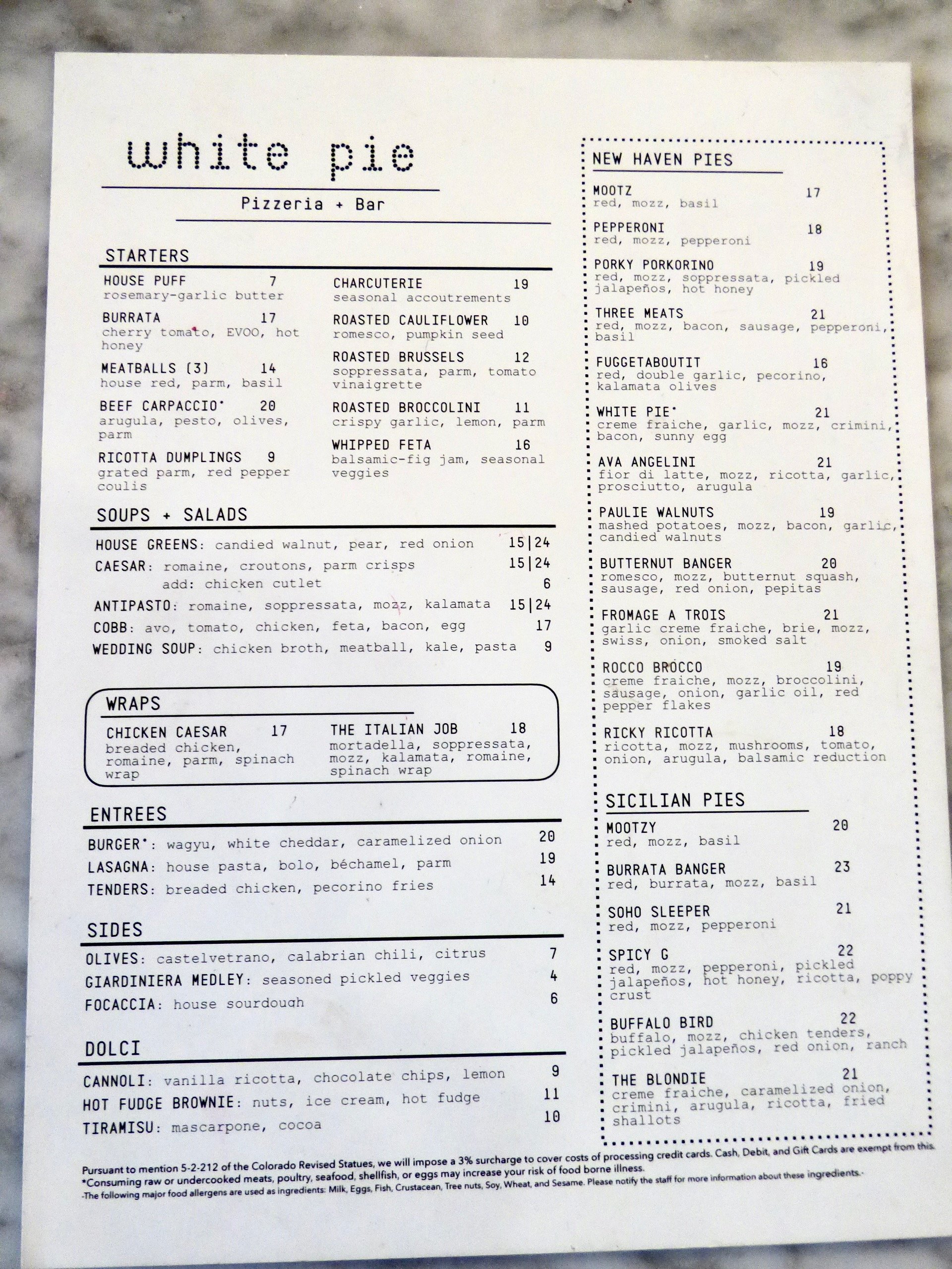 A menu from White Pi, a pizzeria and bar, listing various appetizers, salads, wraps, entrees, sides, and Italian pies, with prices.