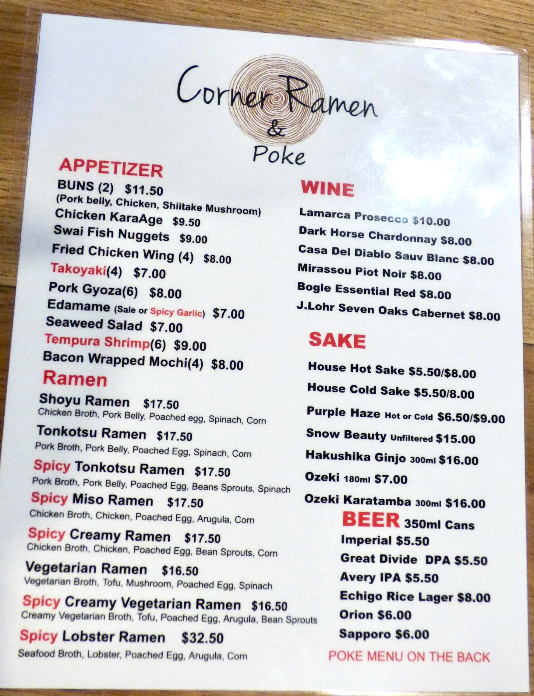 Menu with appetizers, ramen, wine, sake, and beer options at Corner Ramen & Poke restaurant.