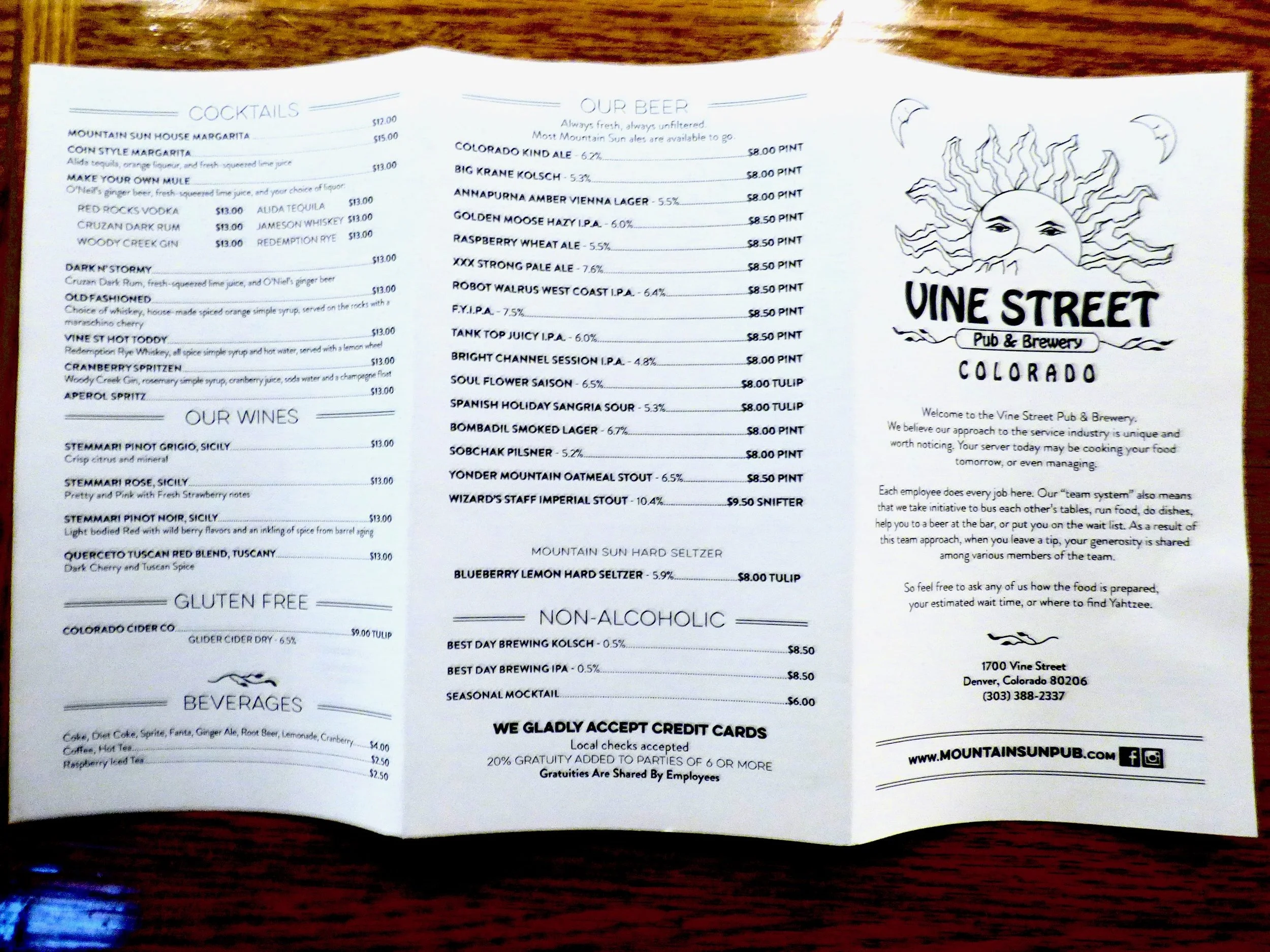 Restaurant menu from Vine Street Pub & Brewery in Colorado, featuring cocktails, beers, wines, gluten-free options, non-alcoholic drinks, and a welcome message with location details at Vine Street Pub, Denver, CO.