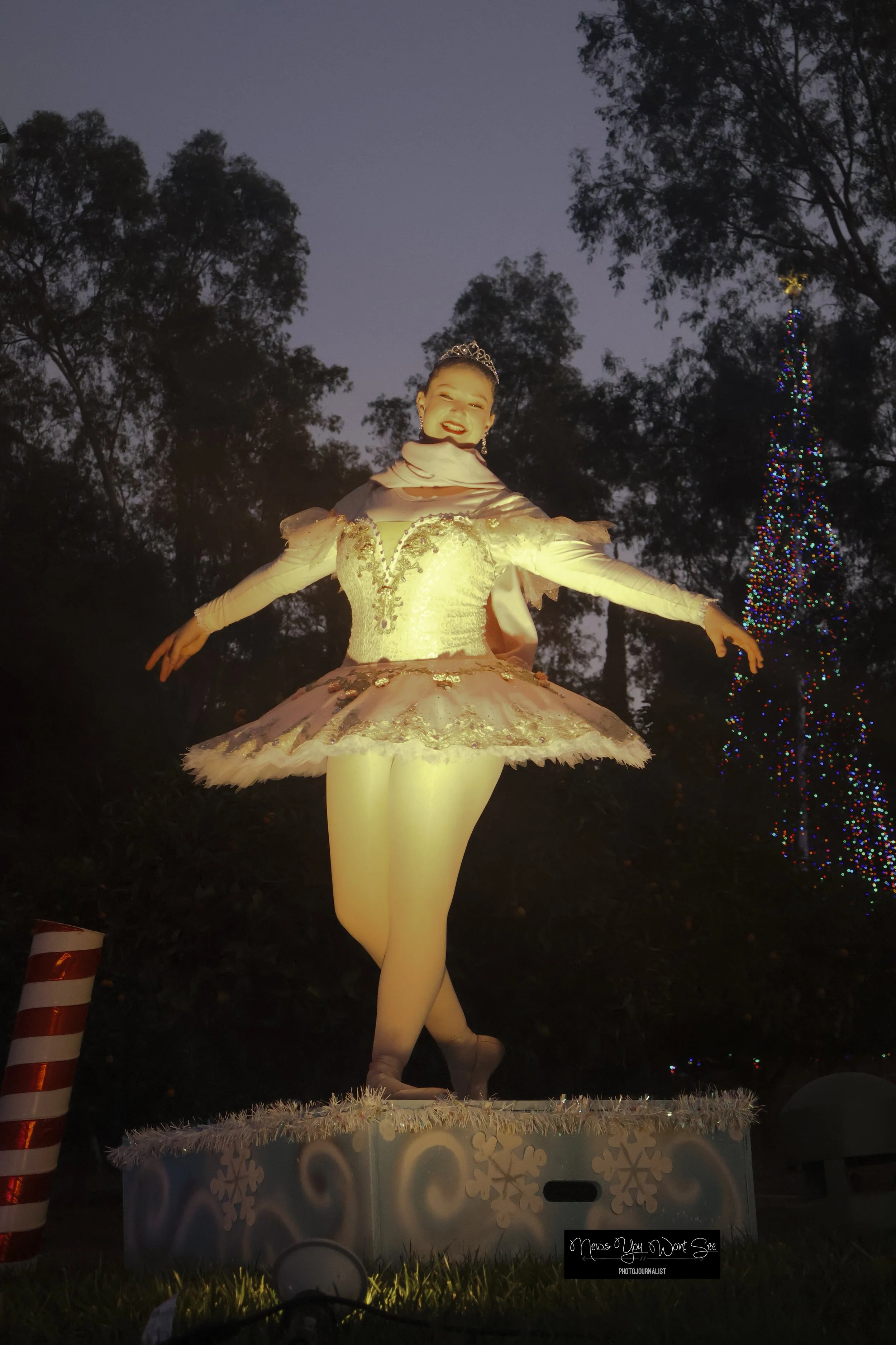  A Volunteer, as seen as a ballerina, makes the Burrage Christmas drive-thru come together. Dec. 14, 2025 ( Photo by Brian Spears, Redlands News Collective) 