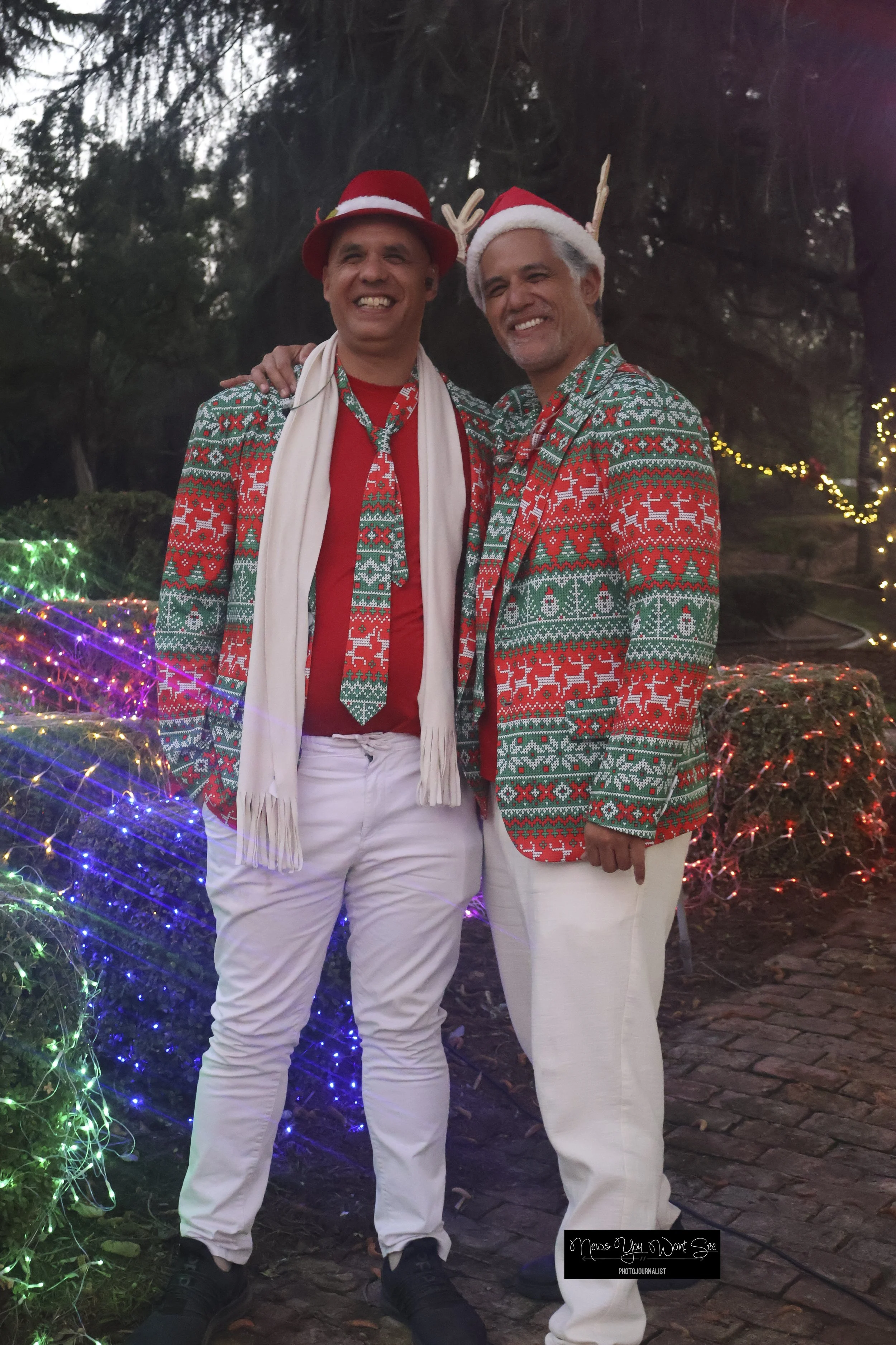  Ryan Keau and Kai Kalama pose before playing Christmas music at the Burrage Christmas drive-thru. Dec. 14, 2025 ( Photo by Brian Spears, Redlands News Collective) 