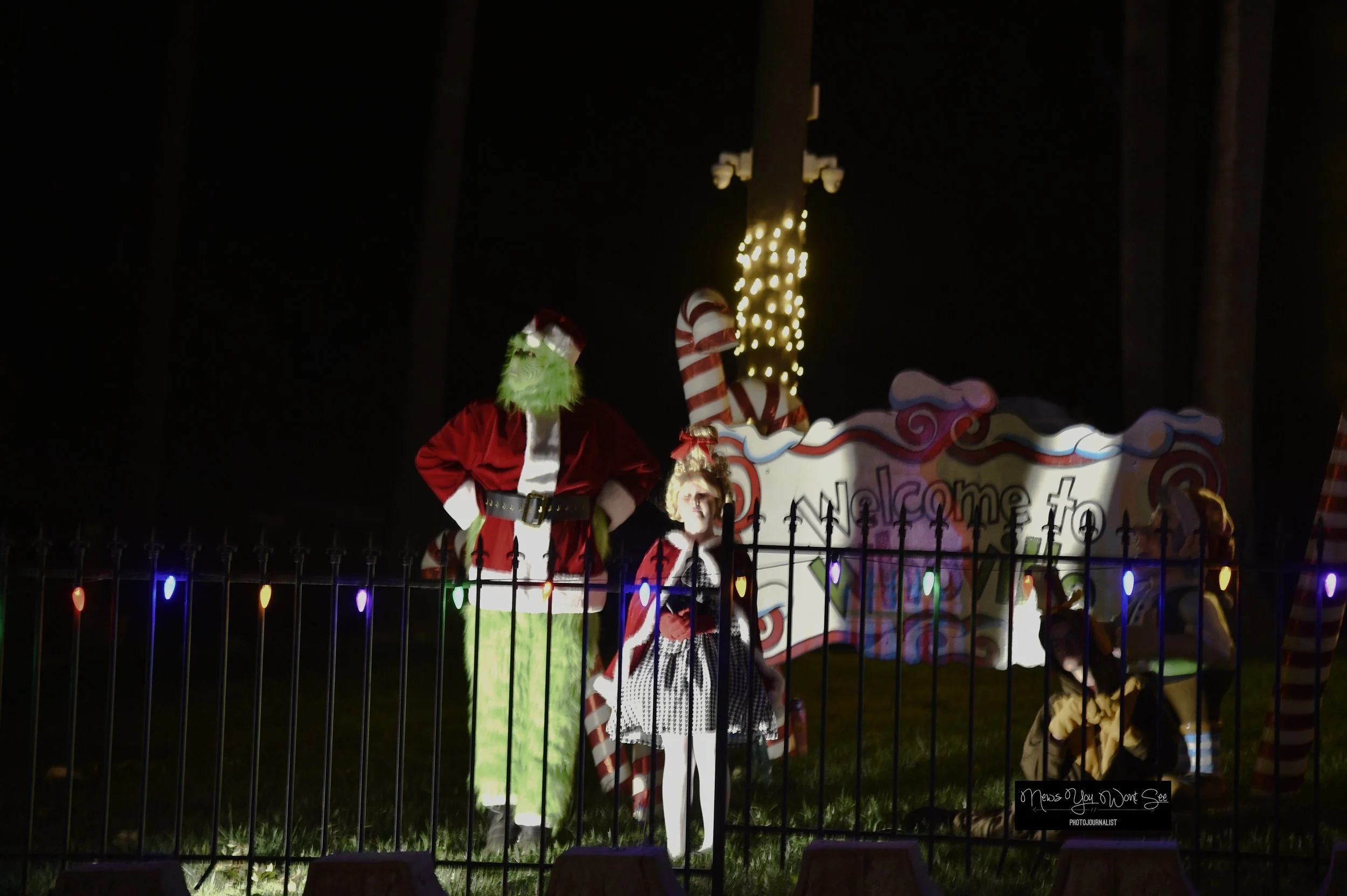  Volunteers, dressed as the Grinch and  Cindy Lou Who ,  make the Burr age Christmas drive-thru come together. Dec. 14, 2025 ( Photo by Brian Spears, Redlands News Collective) 