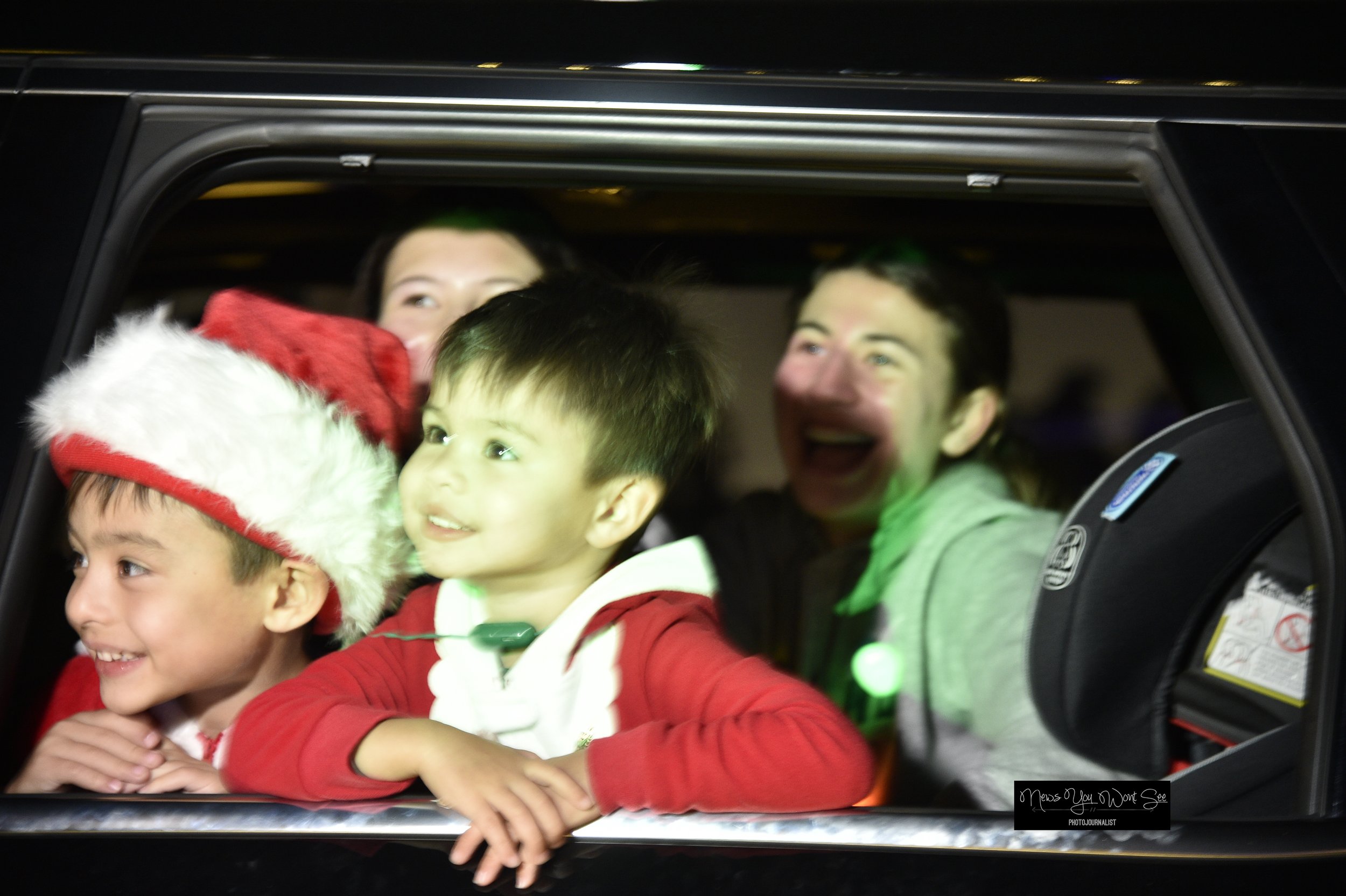  Kids and family members smile at the sights during the Burrage Christmas drive-thru. Dec. 14, 2025 ( Photo by Brian Spears, Redlands News Collective) 