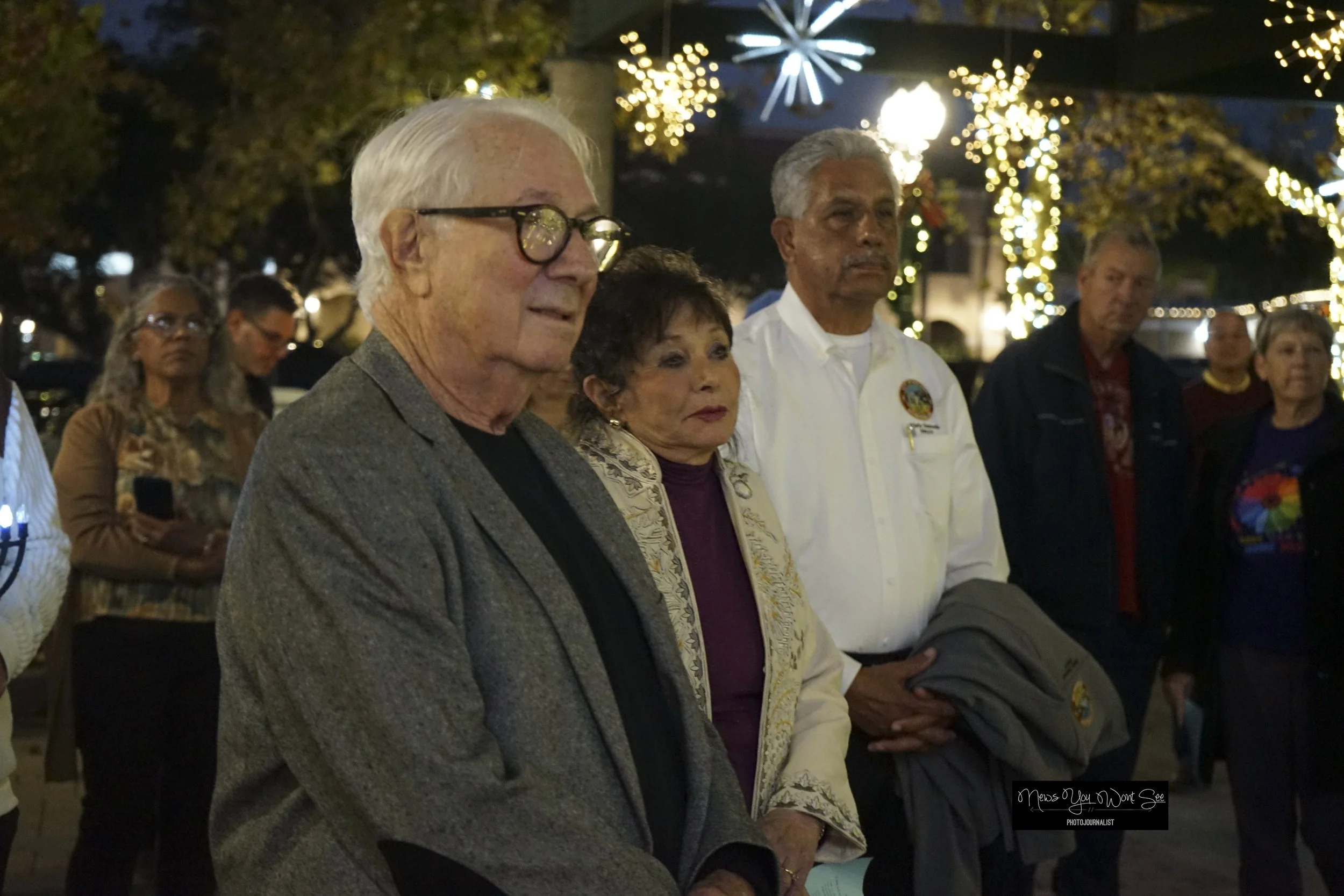  Stan and Elen Weisser stand with Mayor Mario Saucedo at the Light Up the Night event at Ed Hales Park in Redlands, Dec. 20, 2025 (Photo by Brian Spears, Redlands Collective News) 