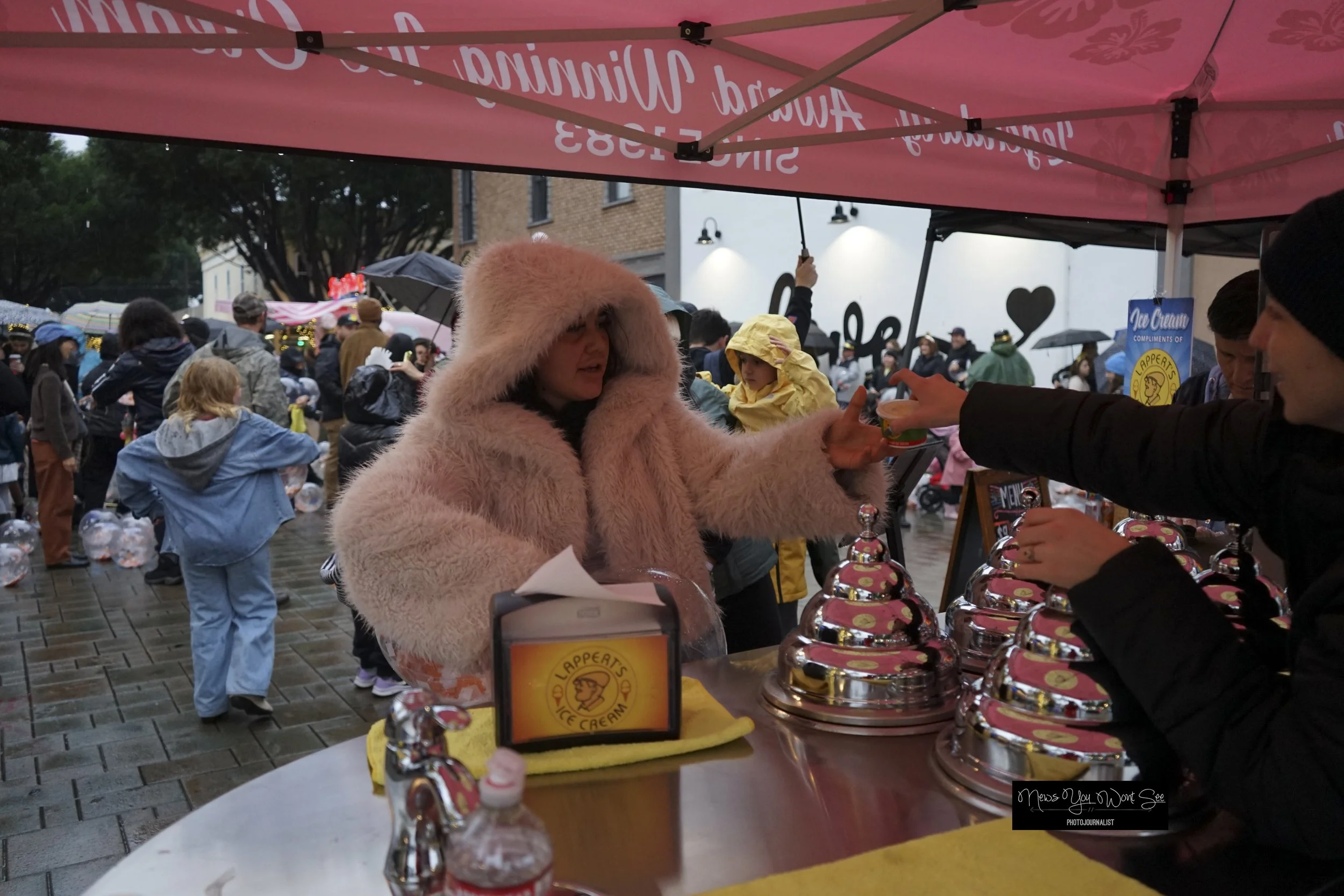  Marian Rodriguez gets a scoop of ice cream compliments of Lapperts at the annual beach ball drop at Ed Hales Park, Dec. 31, 2025. (photo by Brian Spears, Redlands Collective News) 