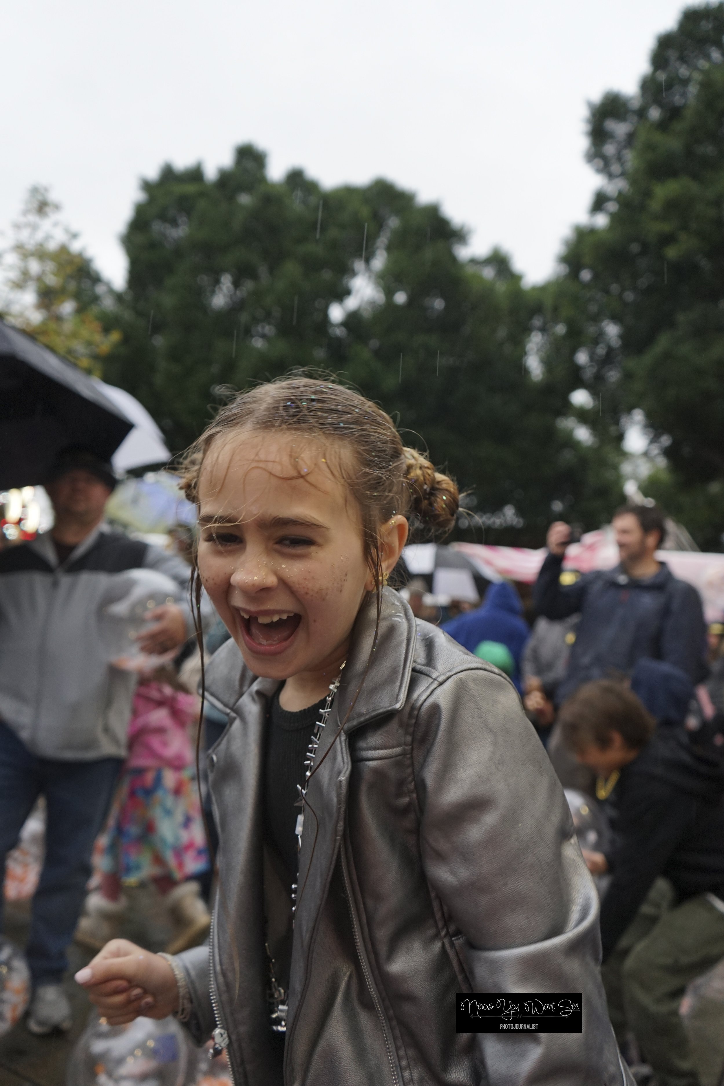  A girl plays with the beach balls as it rains at the annual beach ball drop at Ed Hales Park, Dec. 31, 2025. (photo by Brian Spears, Redlands Collective News) 