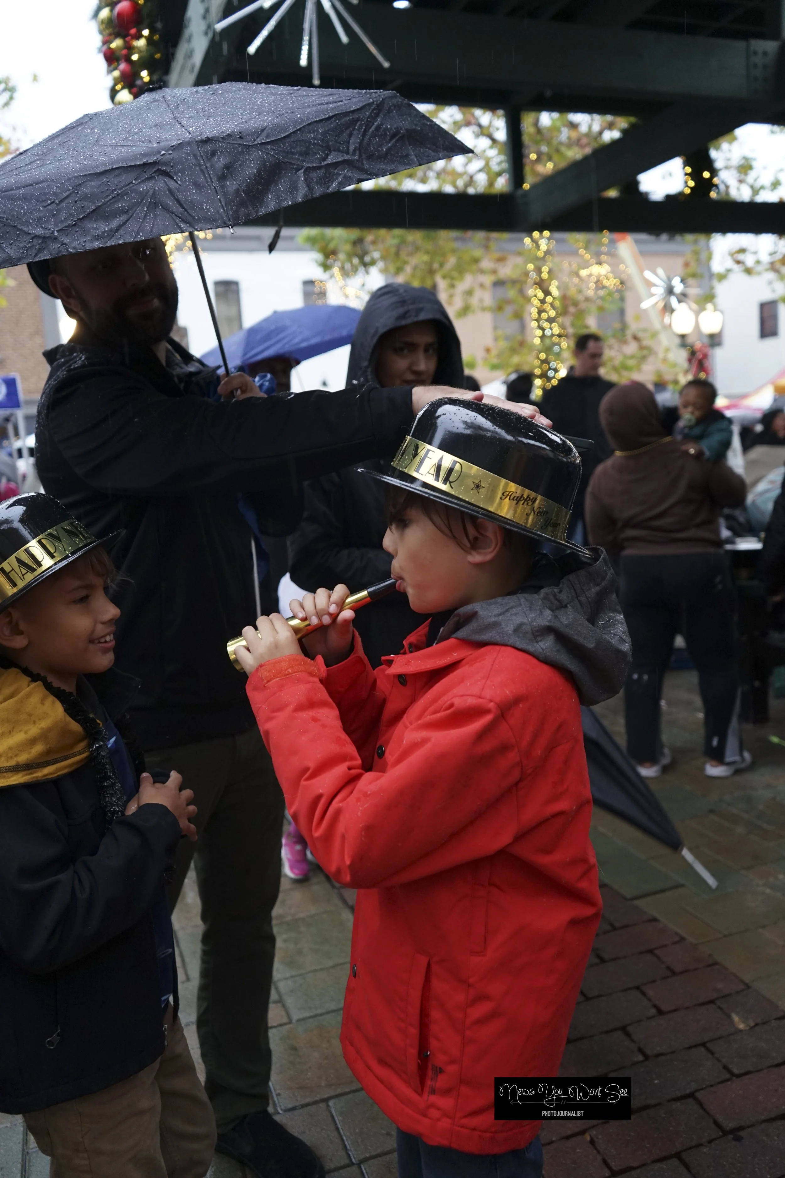  9-year-old Nash Austen blows a horn during the annual beach ball drop at Ed Hales Park, Dec. 31, 2025. (photo by Brian Spears, Redlands Collective News)  