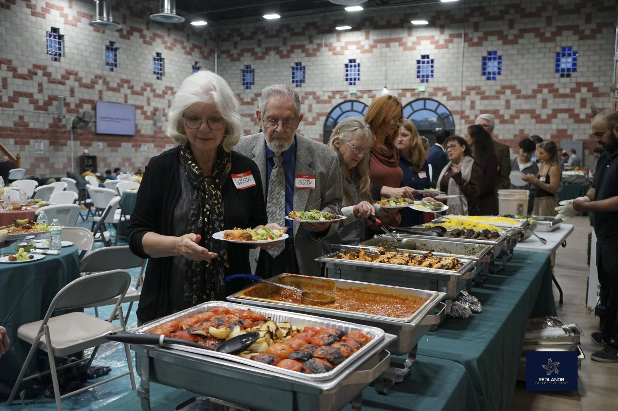  The interfaith community get food to cellibrate Iftar at the Interfaith Ramadan Iftar at The Islamic Community Center of Redlands on Feb. 22, 2026 