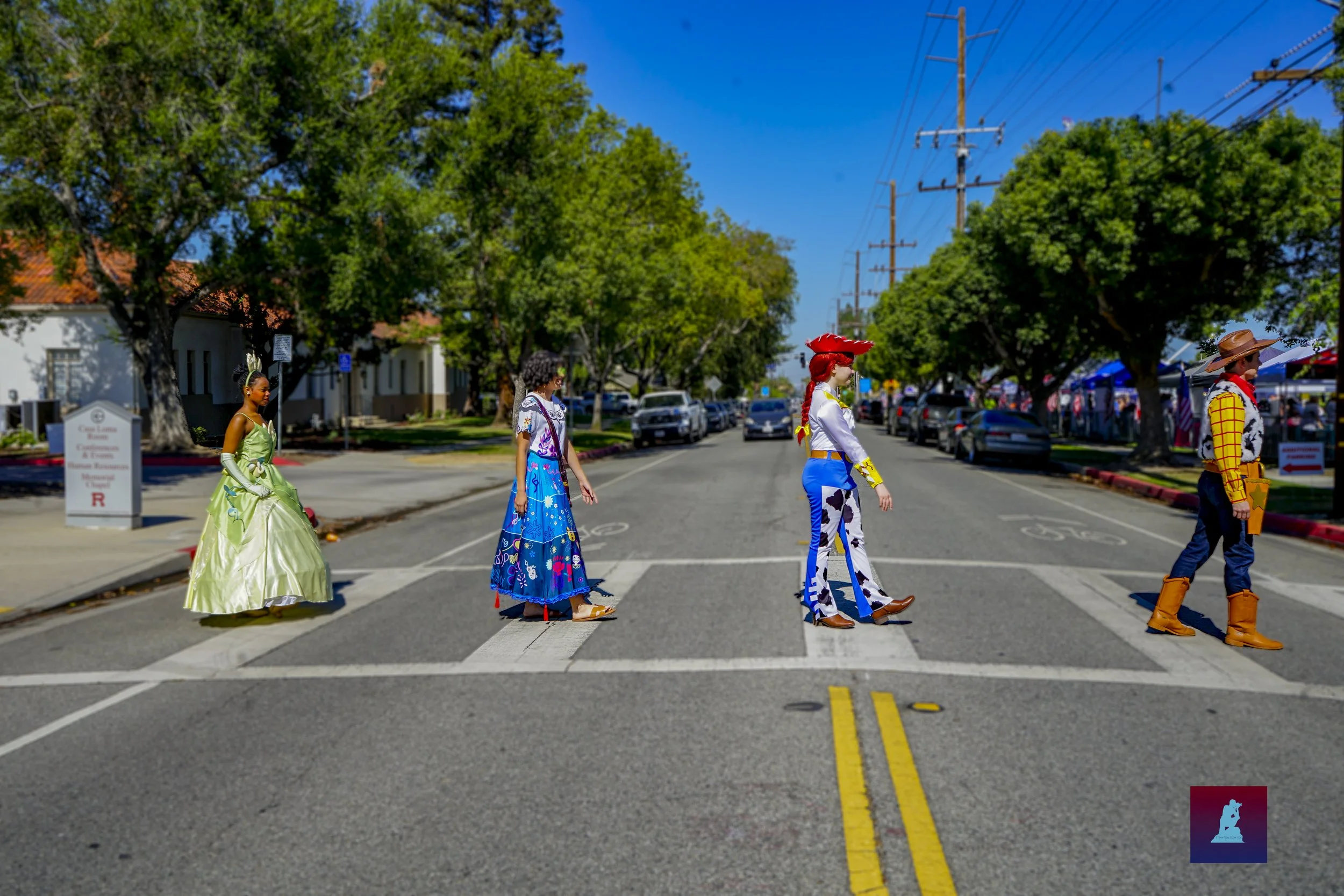  Members dressed as Disney caricters walk across the street bfore the event 