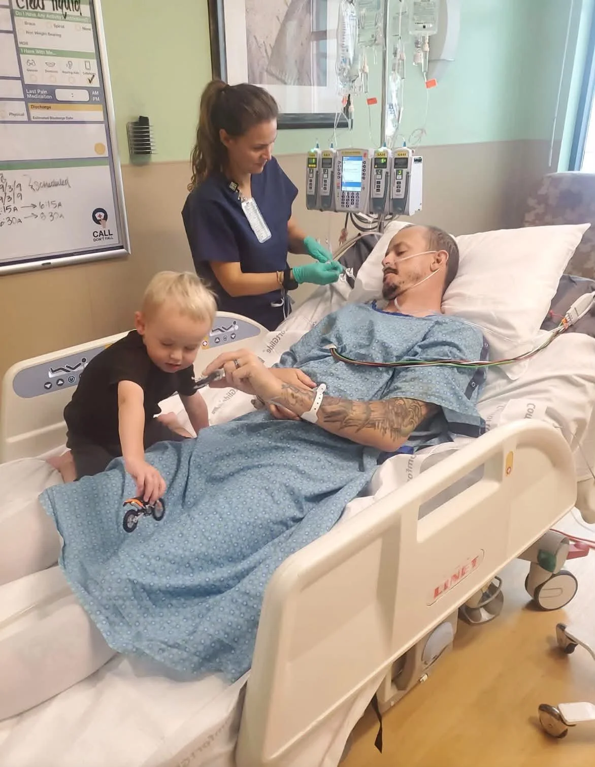 Buyten in bed after accident w son Jett.jpg
