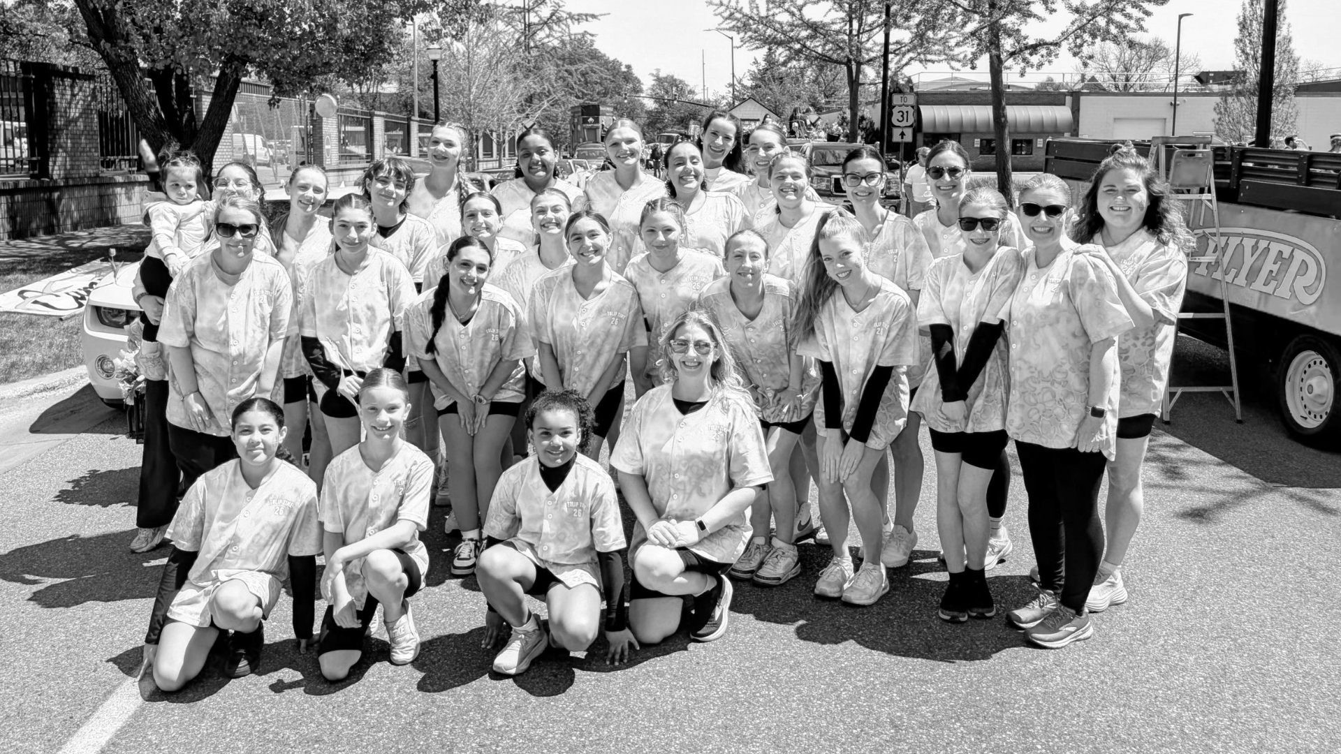 Group of smiling people at a parade.