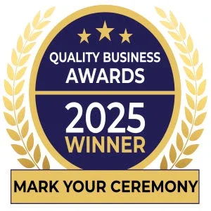 Gold and navy badge with three stars at the top, displaying 'Quality Business Awards 2025 Winner' and a space for marking a ceremony.