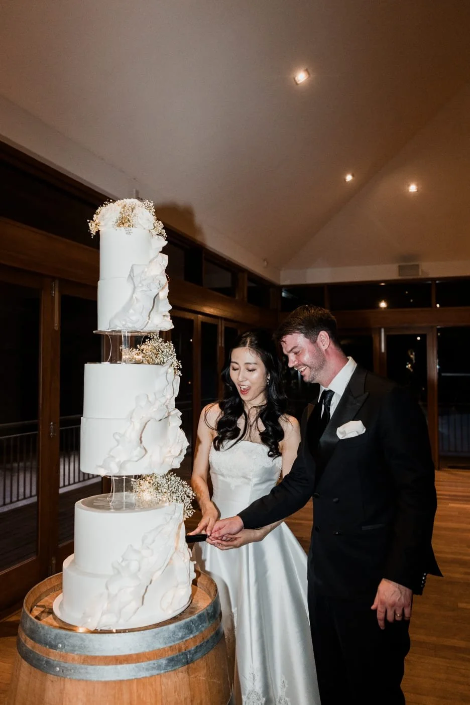 couple-cutting-cake-in-reception