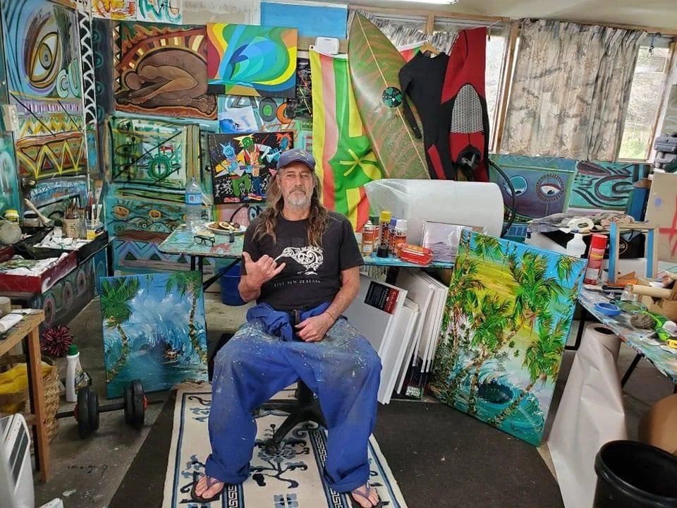 Steven Valiere in his surf art studio, surrounded by his art