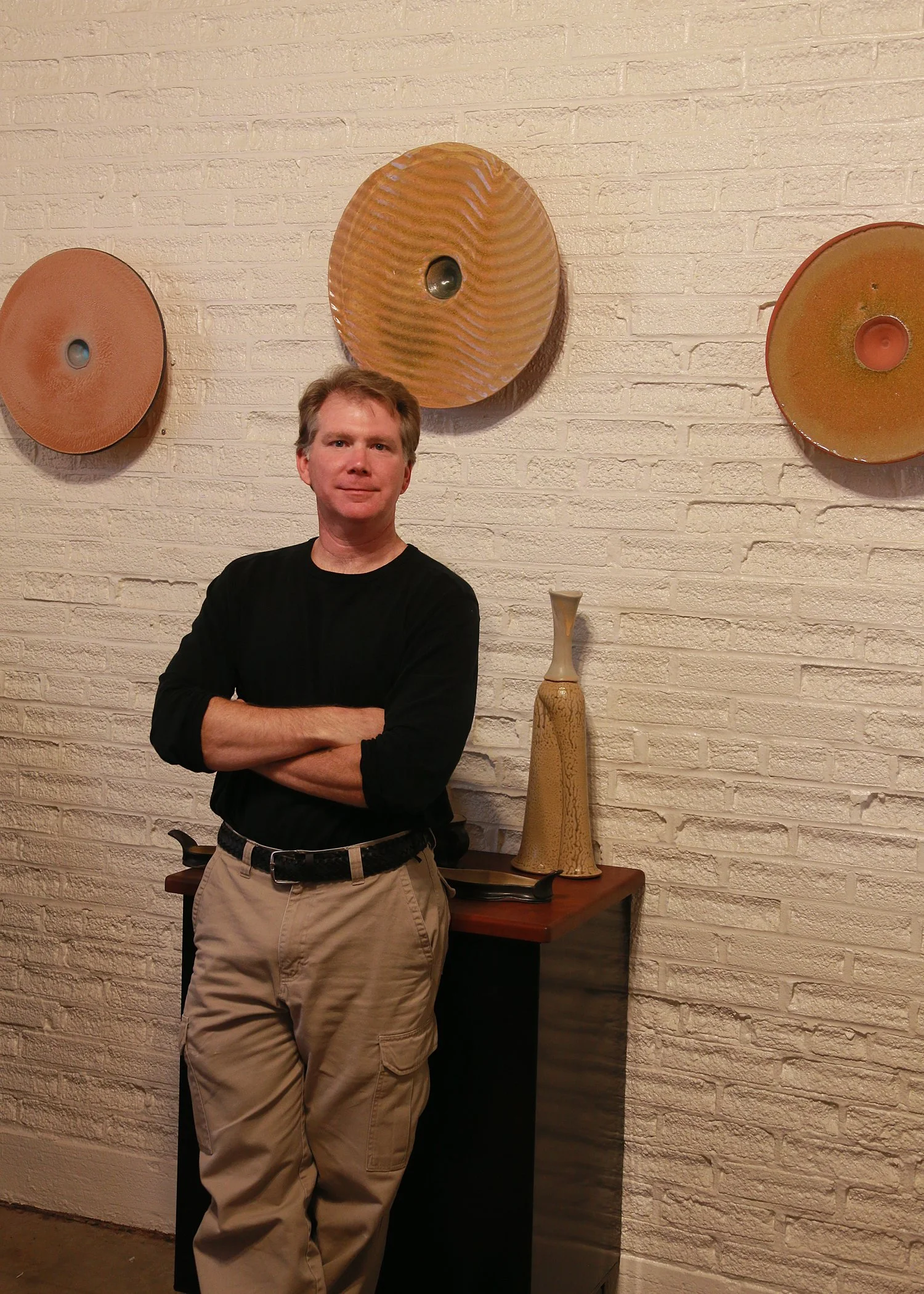 Conner Burns in his gallery with disc series artwork.