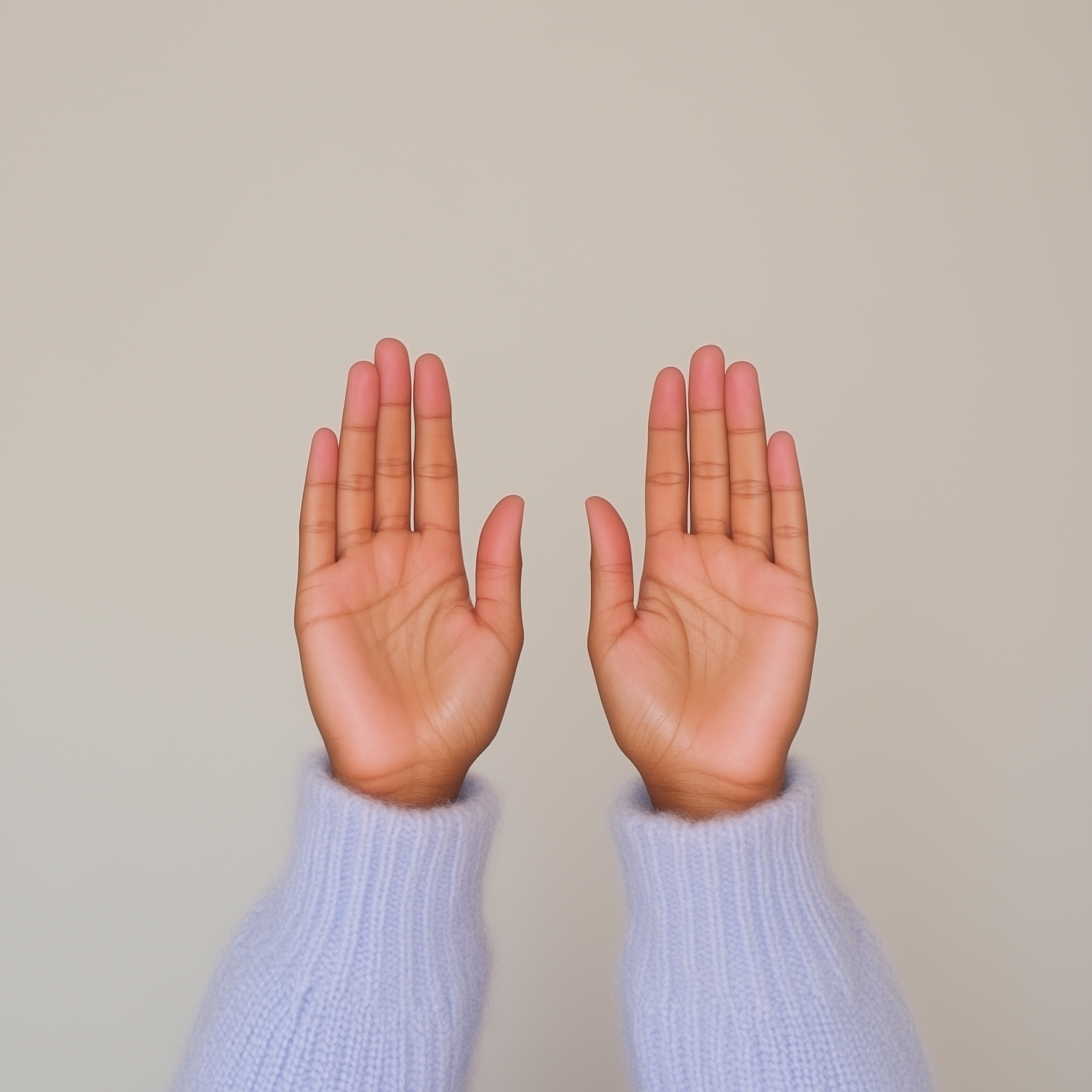 Close-up of two hands with fingers extended, positioned against a plain background, with colored shadows cast below.
