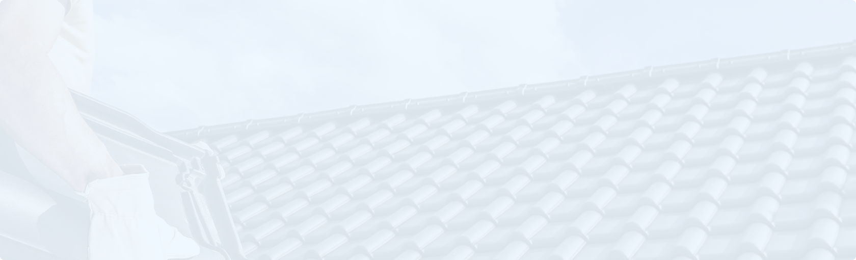 Worker installing roof tiles on a house roof.