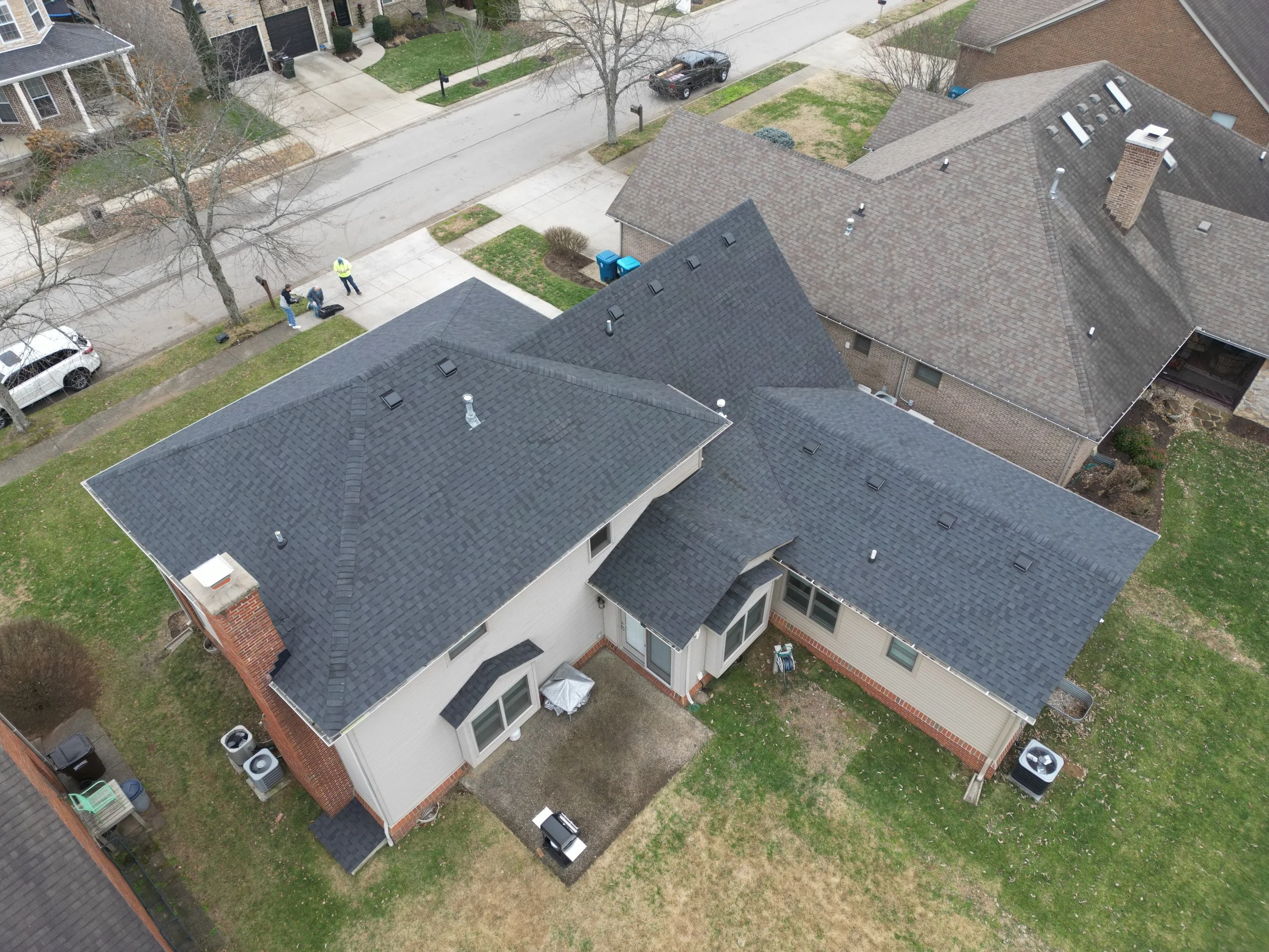 Aerial view of completed roof replacement in Lexington Kentucky featuring Owen's Corning TruDefinition Onyx Black asphalt shingles on residential home