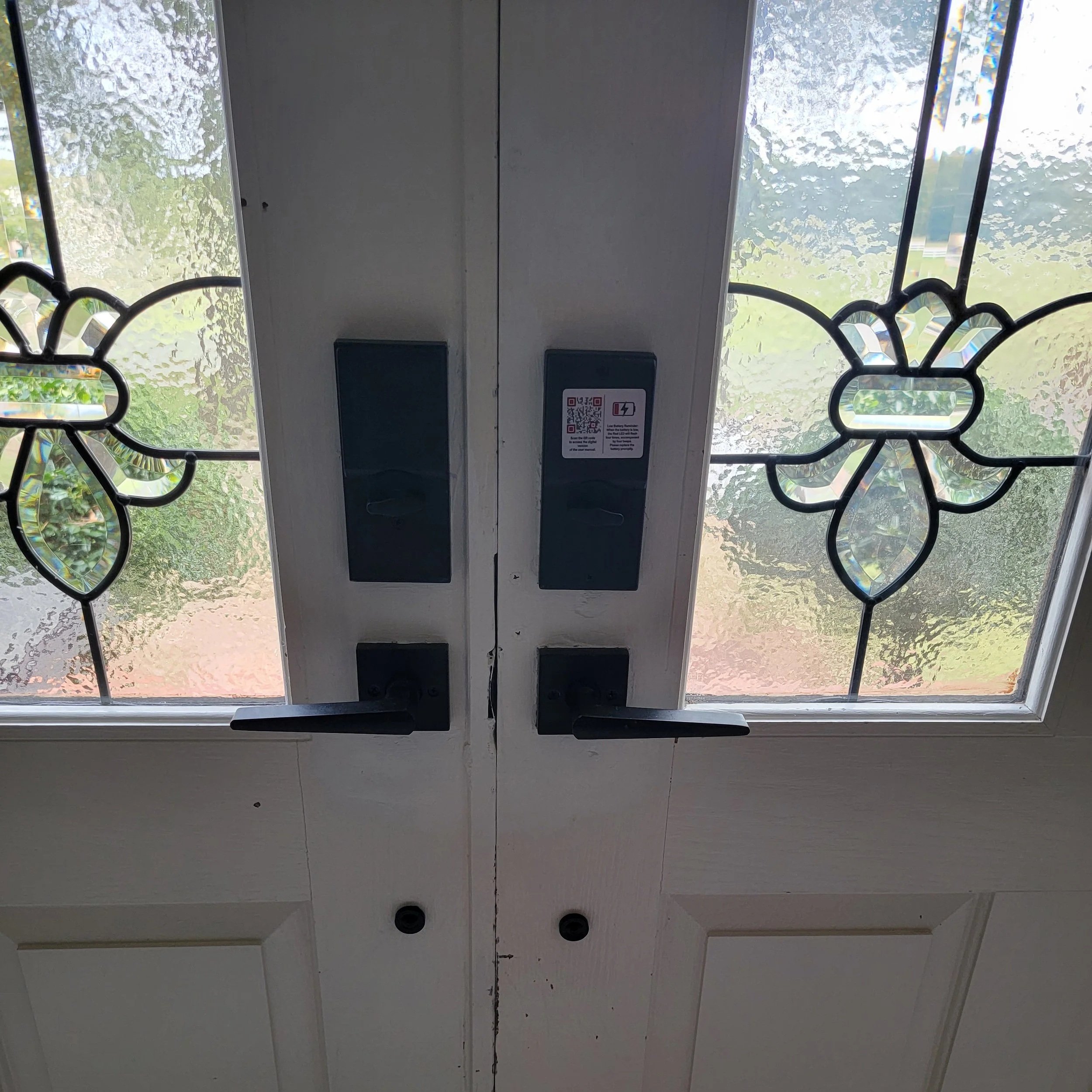 Double front door with decorative stained glass windows, electronic door locks, and RFID access panels.