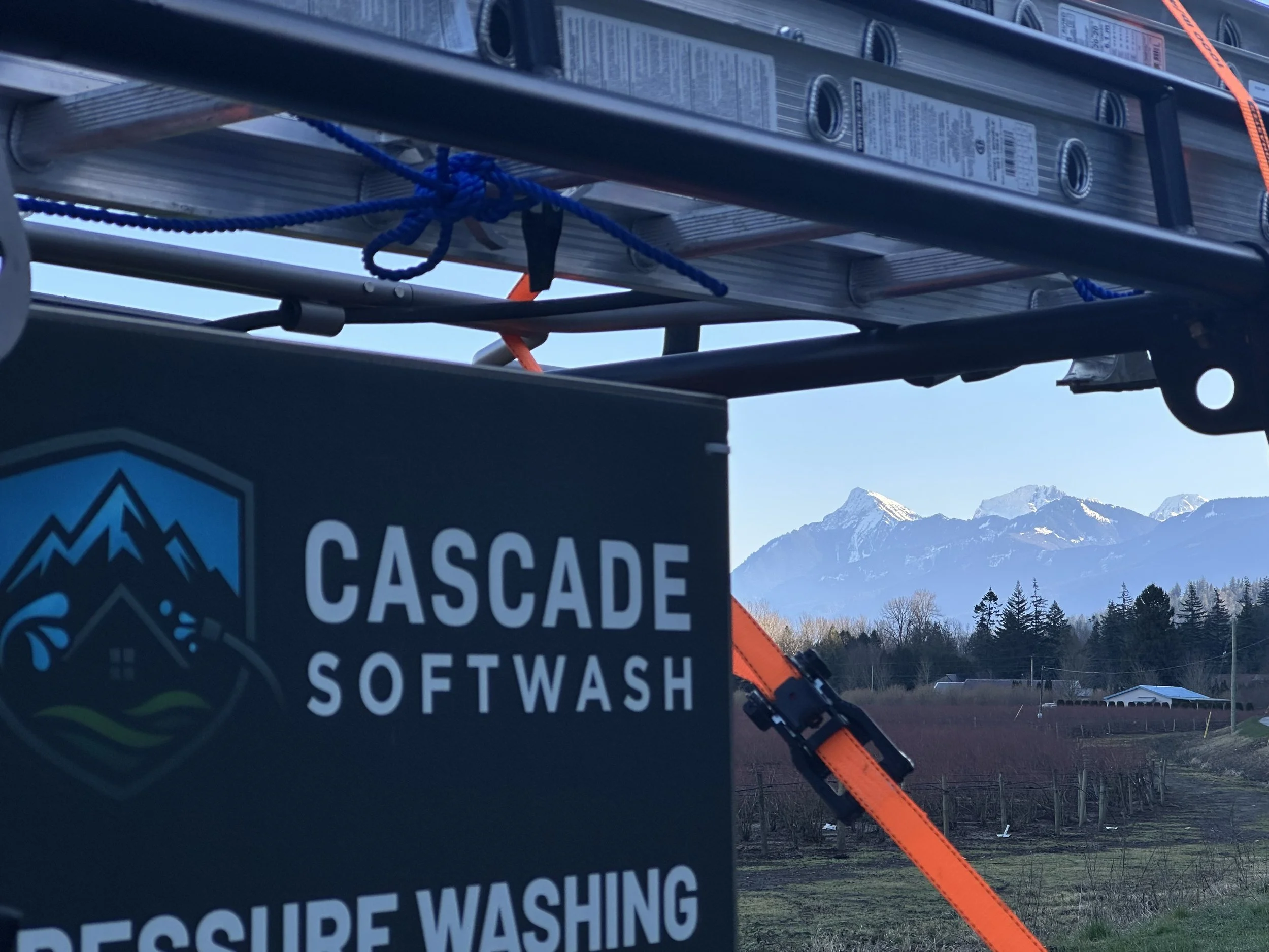 A Cascade Softwash pressure washing machine with a view of mountains in the background.