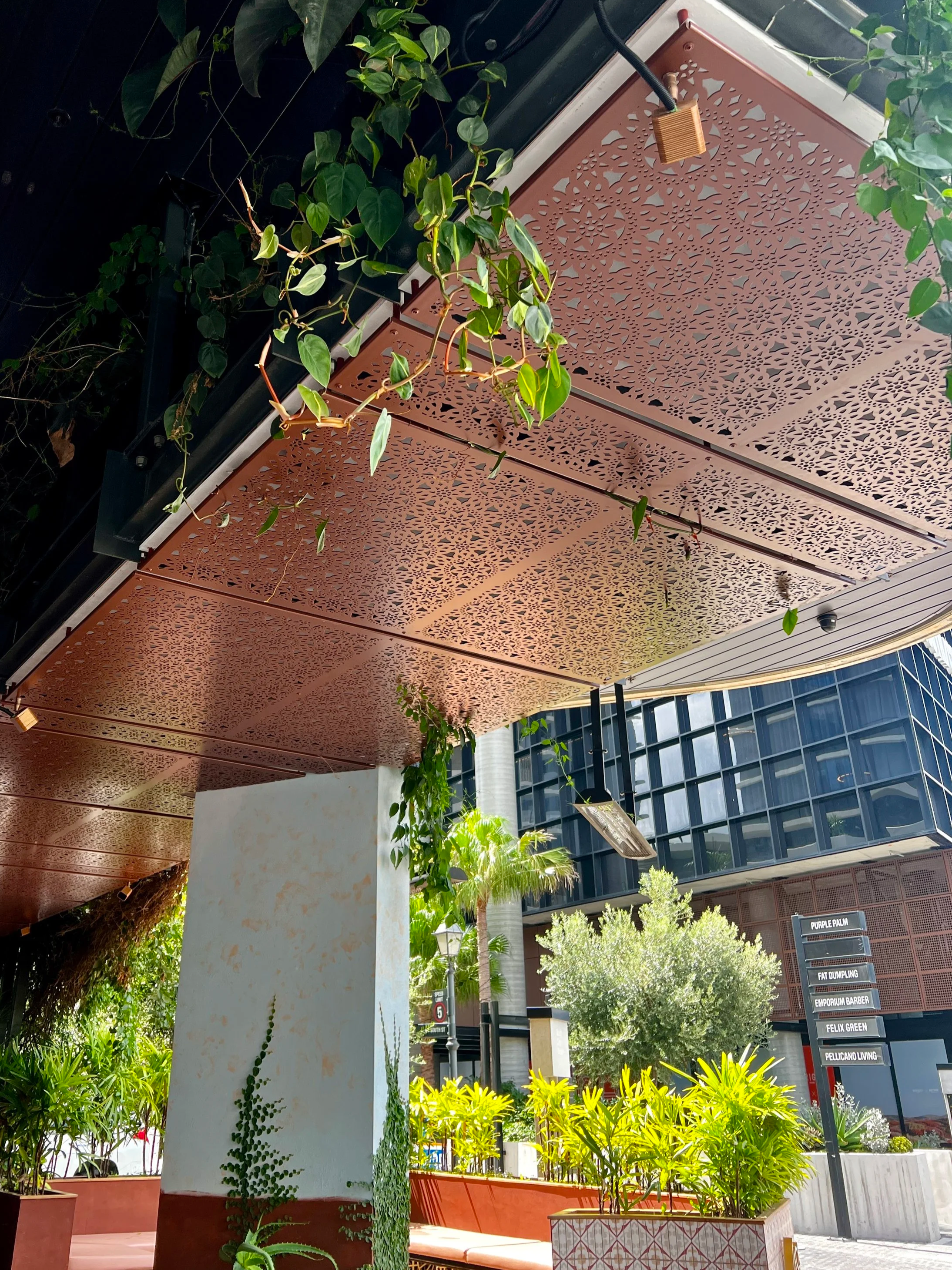 Commercial fit for UNITA. Decorative facade screens for exterior ceiling panels. Decorative panels are backlit. Laser cut screens in Urban Metal Lace design. Powder coated Dulux Weathered Steel. Each screen has folded edges and custom mounting