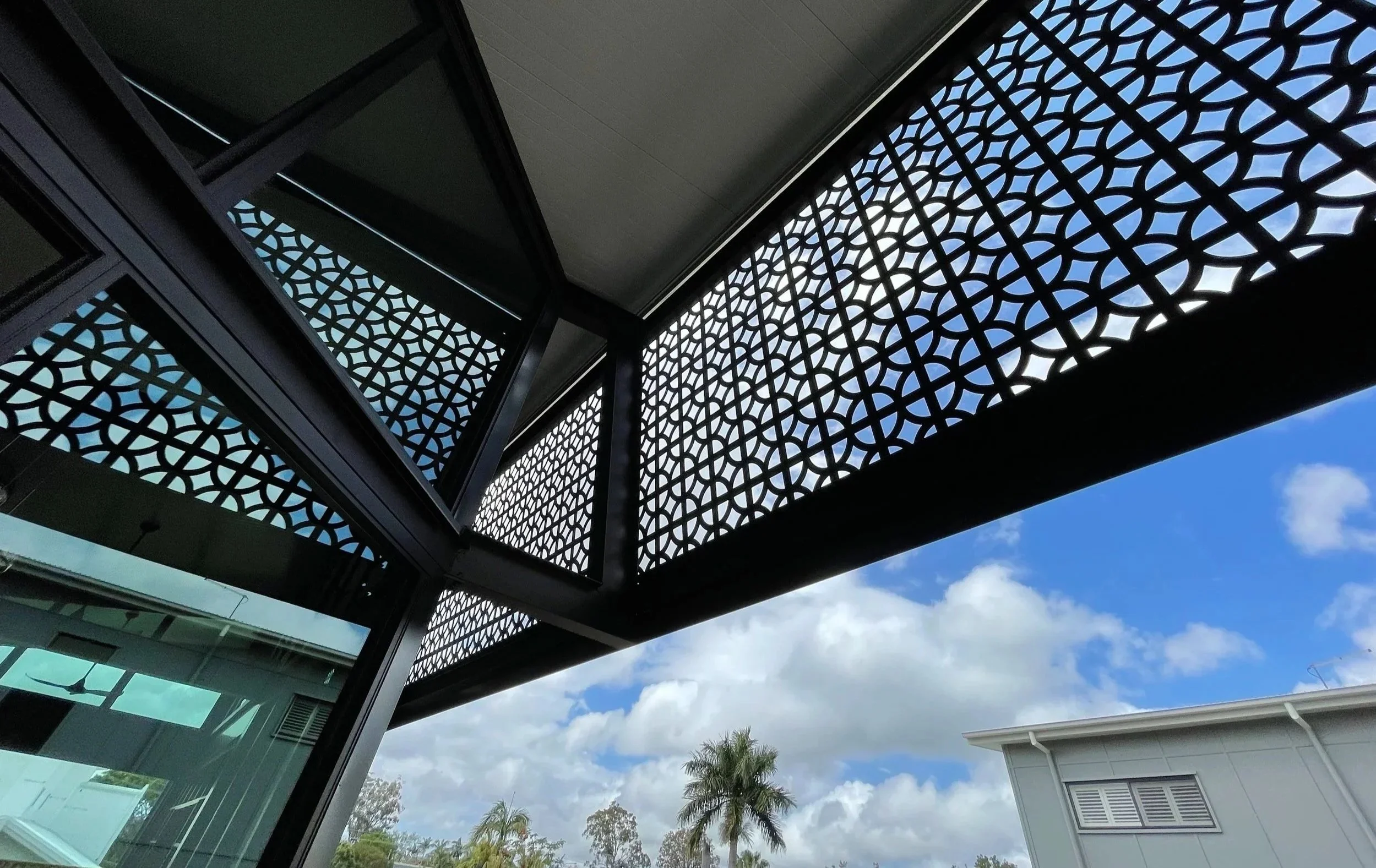 Decorative laser cut screens for residential exterior facade. Project for Petroff Constructions. Urban Metal breeze block design. Powder coated Dulux Monument. Oversized panels with custom framework