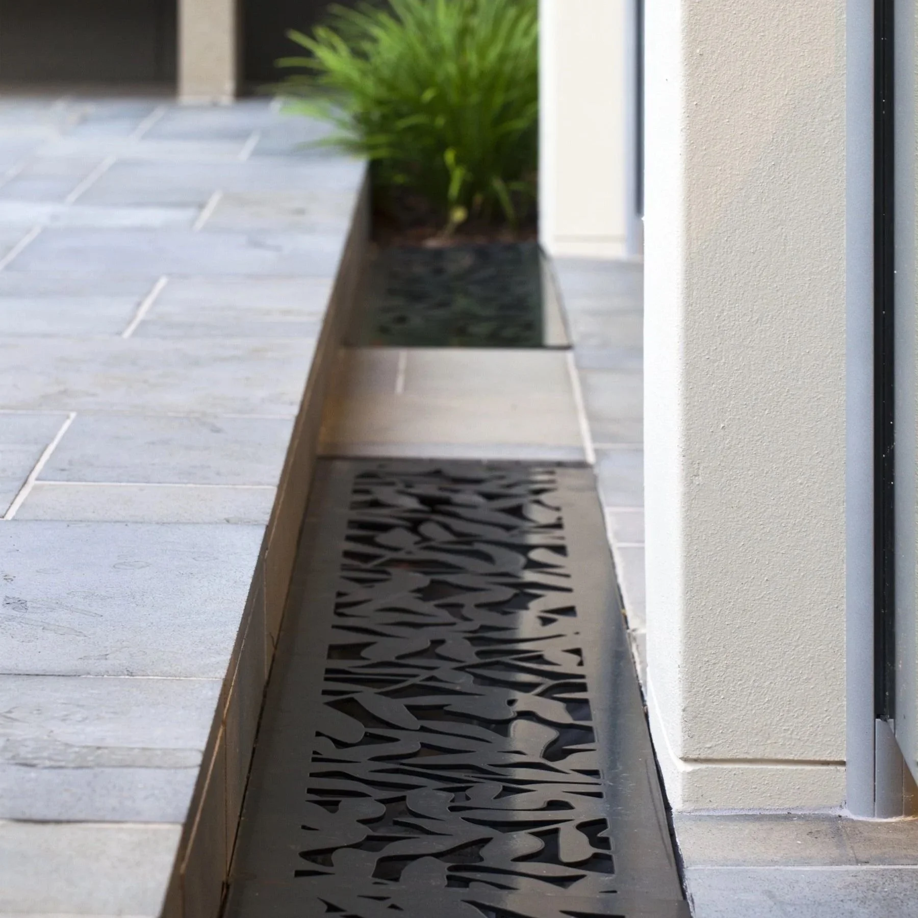 Utopia Landscapes custom designed drainage cover laser cut. Urban Metal leaves design