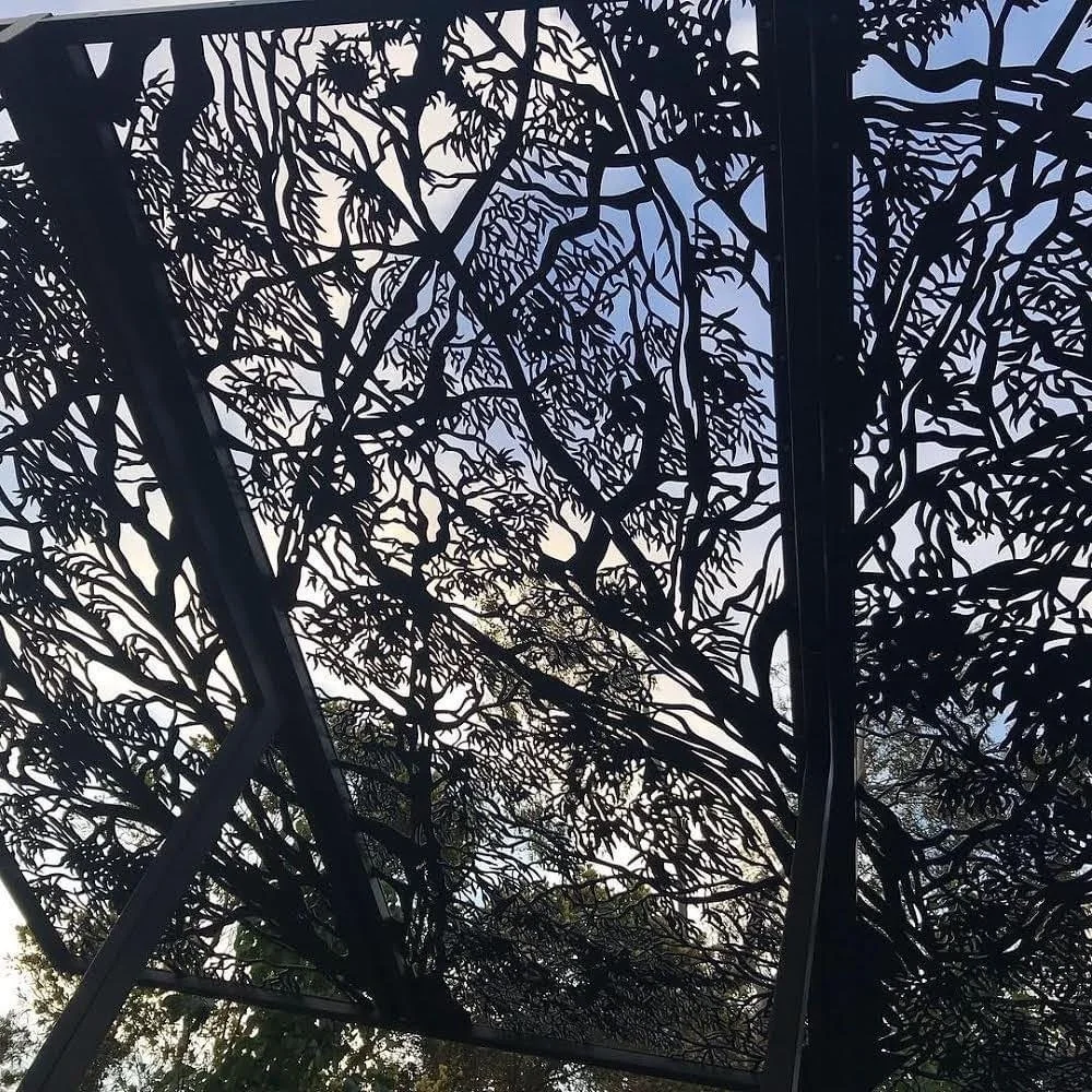 Custom designed shade canopy for alfresco area. Laser cut steel. Red river gum leaf design