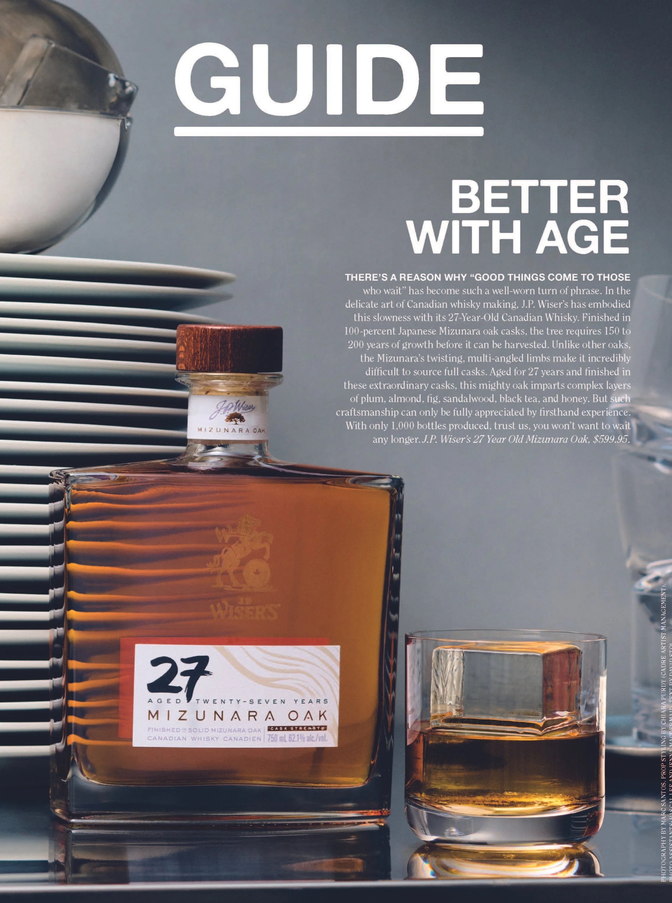A guide about aging whisky featuring a bottle of Mizunara Oak whisky, a glass of whisky, and a stack of white plates in the background. The text discusses the craftsmanship and aging process of the whisky.