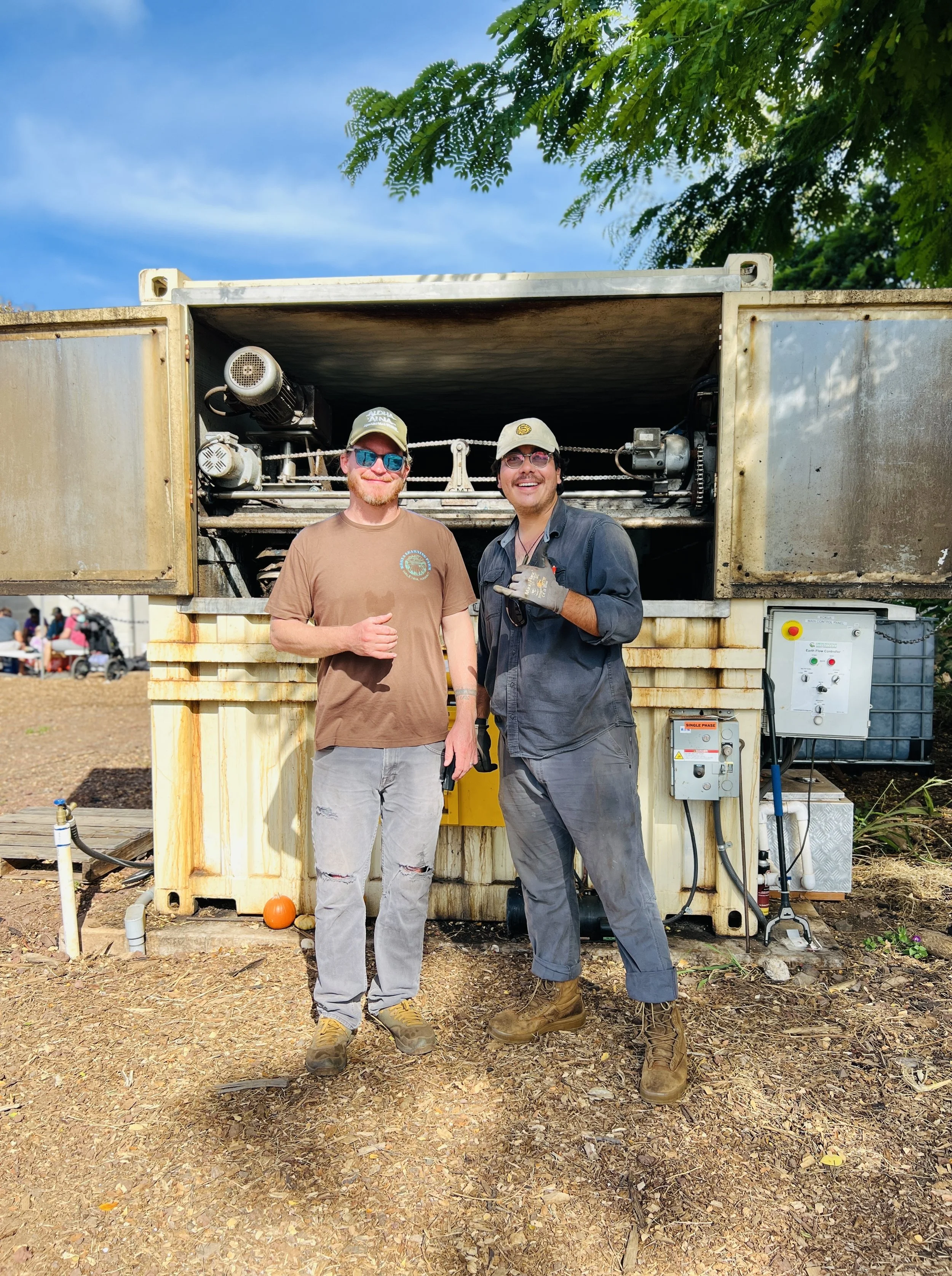Hands holding a handful of soil with dust particles falling.