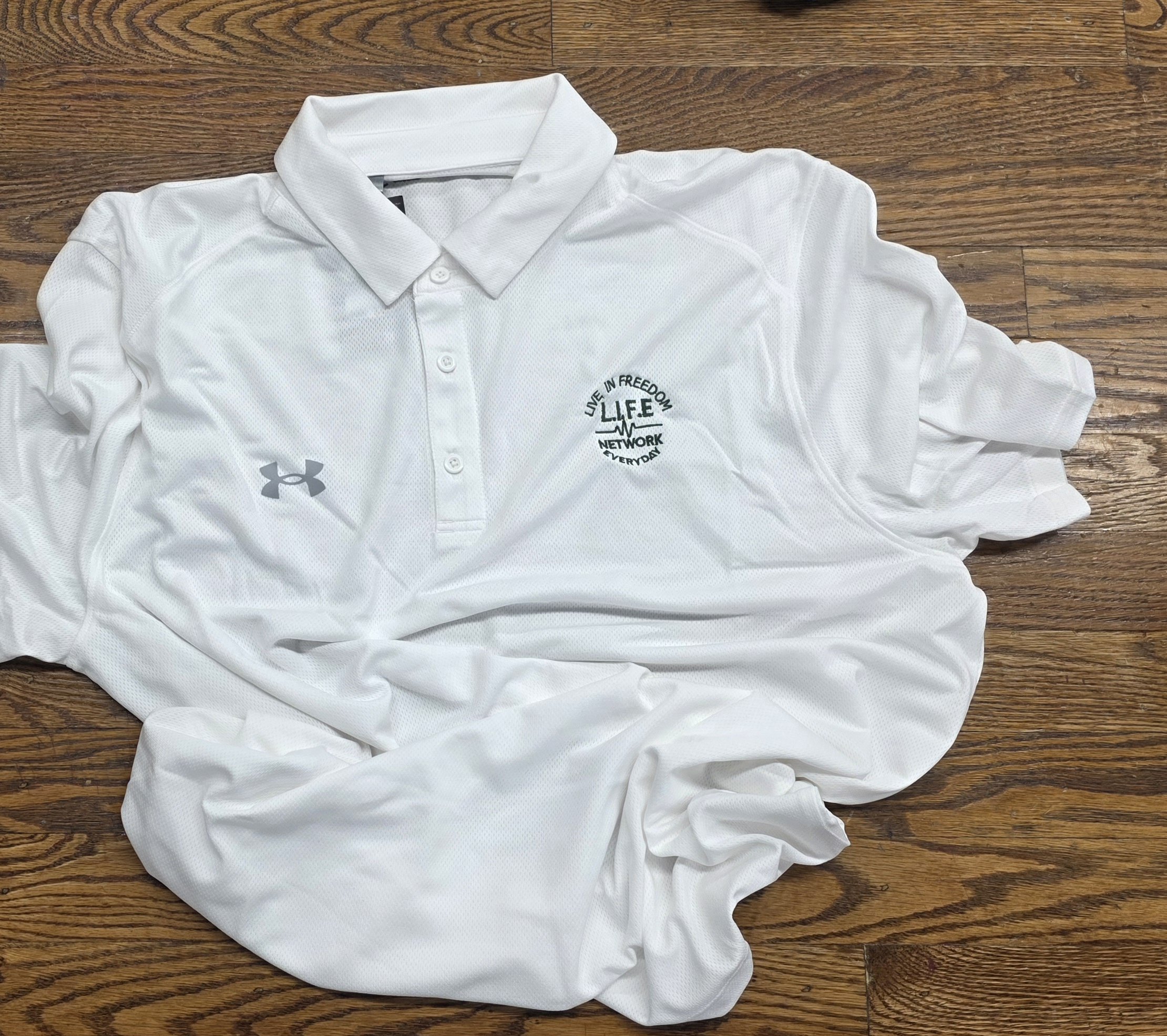 White UA Polo w - green writting.jpg