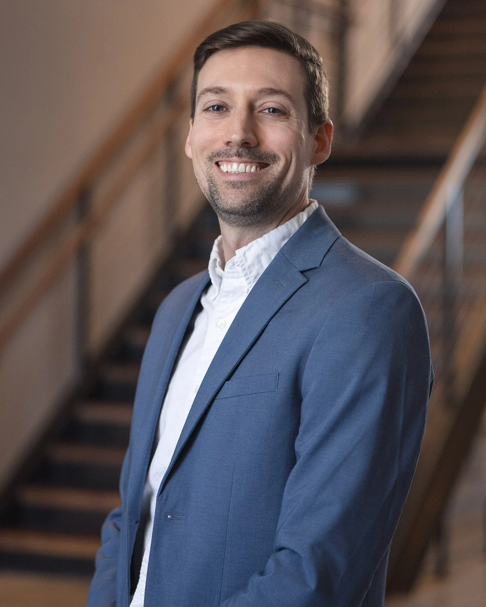 Matt Reynolds, founder of Trellis Advisory, standing with a suit jacket and white shirt.