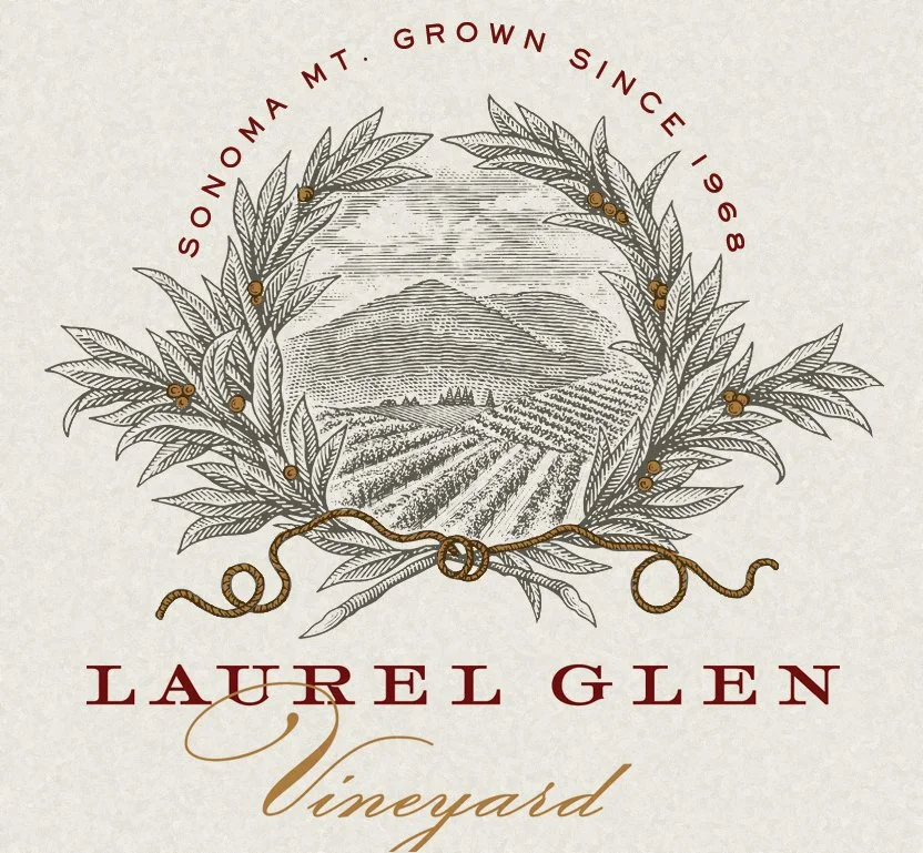 A wine label featuring a black and white illustration of a mountain and vineyard, encircled by a laurel wreath. The text reads "Sonoma Mt. Grown Since 1968," "Laurel Glen," and "Vineyard."