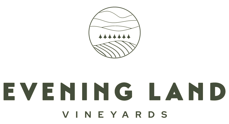 Evening Land Vineyards logo with a circular illustration of land, sky, and trees