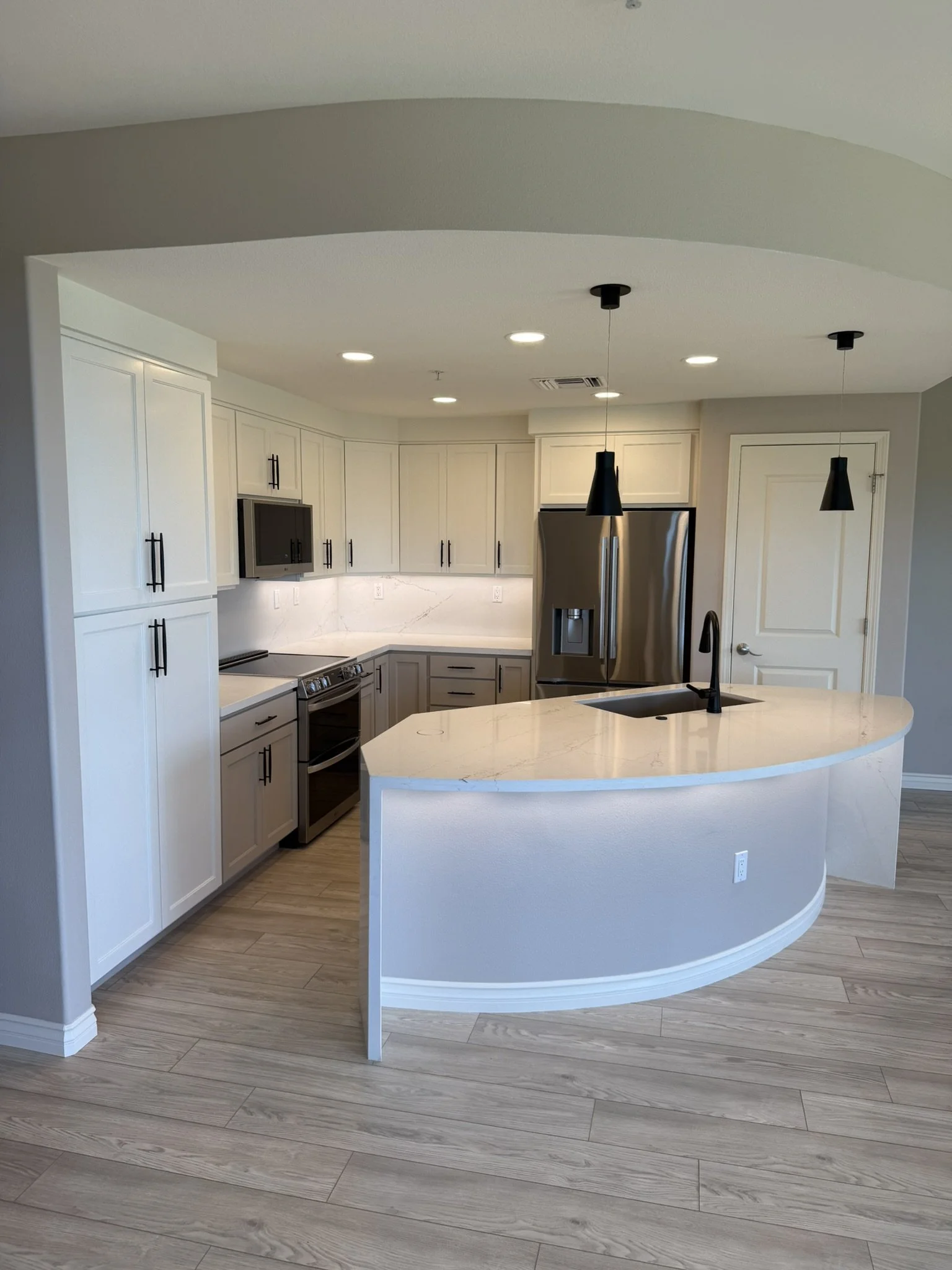 Kitchen renovation with stainless appliances and quartz backsplash at Ke Alii Ocean Villas, Kihei, Maui