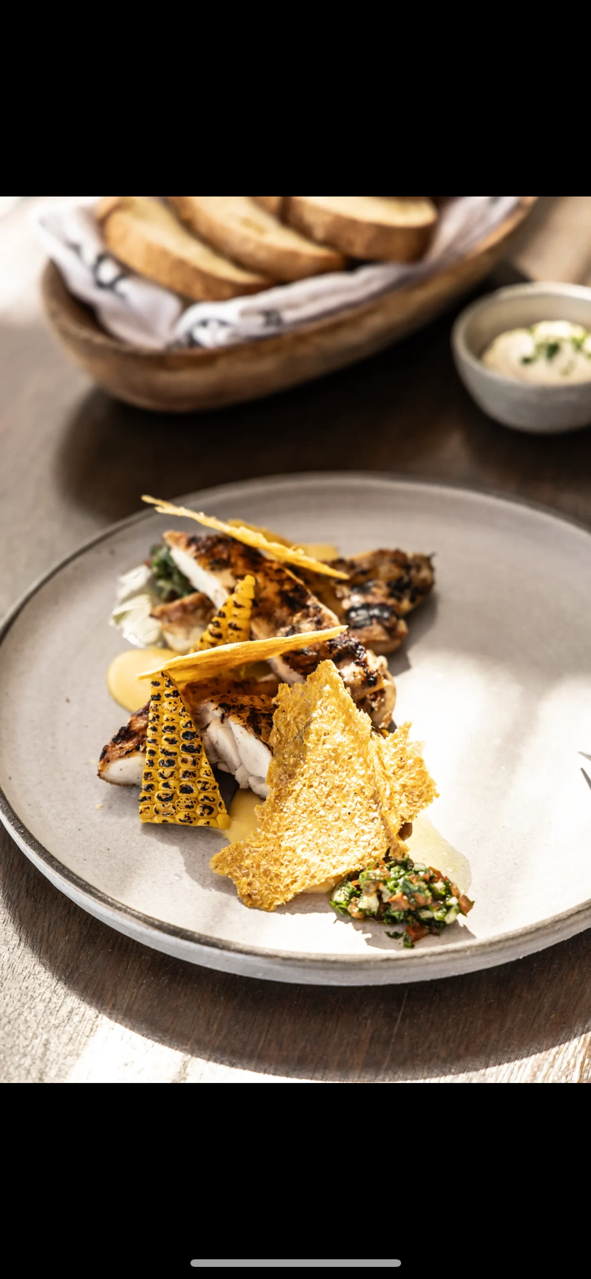 Juicy chicken thigh with corn textures and tomato relish